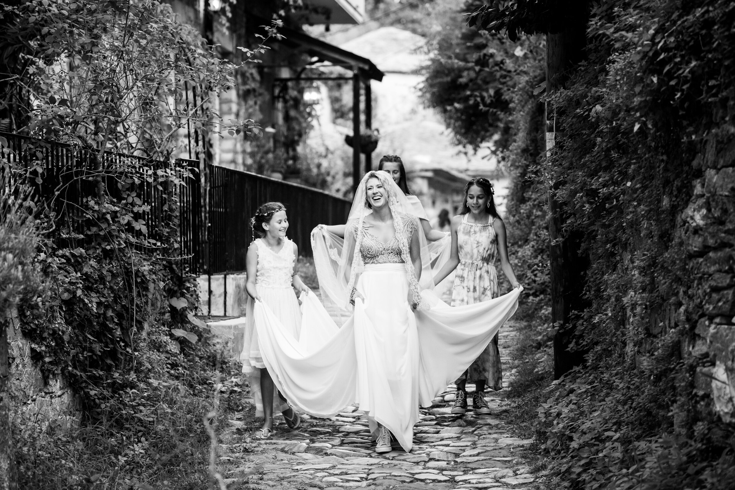 Bride and flower girls process to the wedding ceremony:  destination wedding photo at the Lost Unicorn Hotel, Tsagarada, Greece by J. Brown Photography.