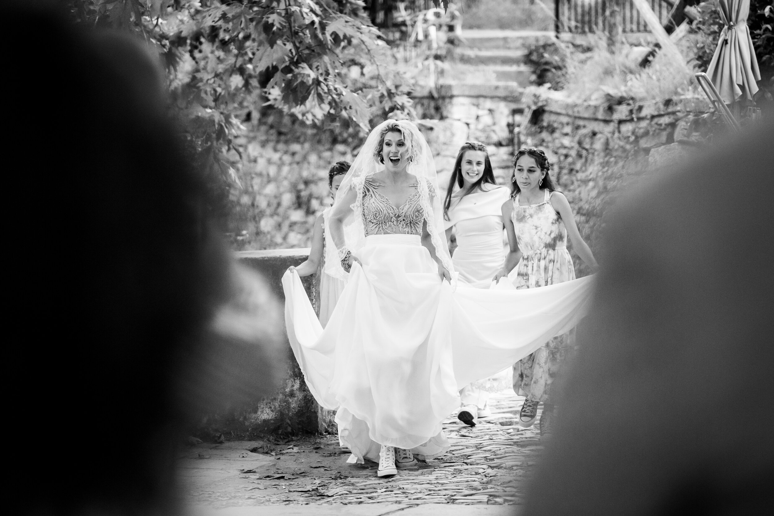 Bride reacts as she comes to the ceremony site on her wedding day:  destination wedding photo at the Lost Unicorn Hotel, Tsagarada, Greece by J. Brown Photography.