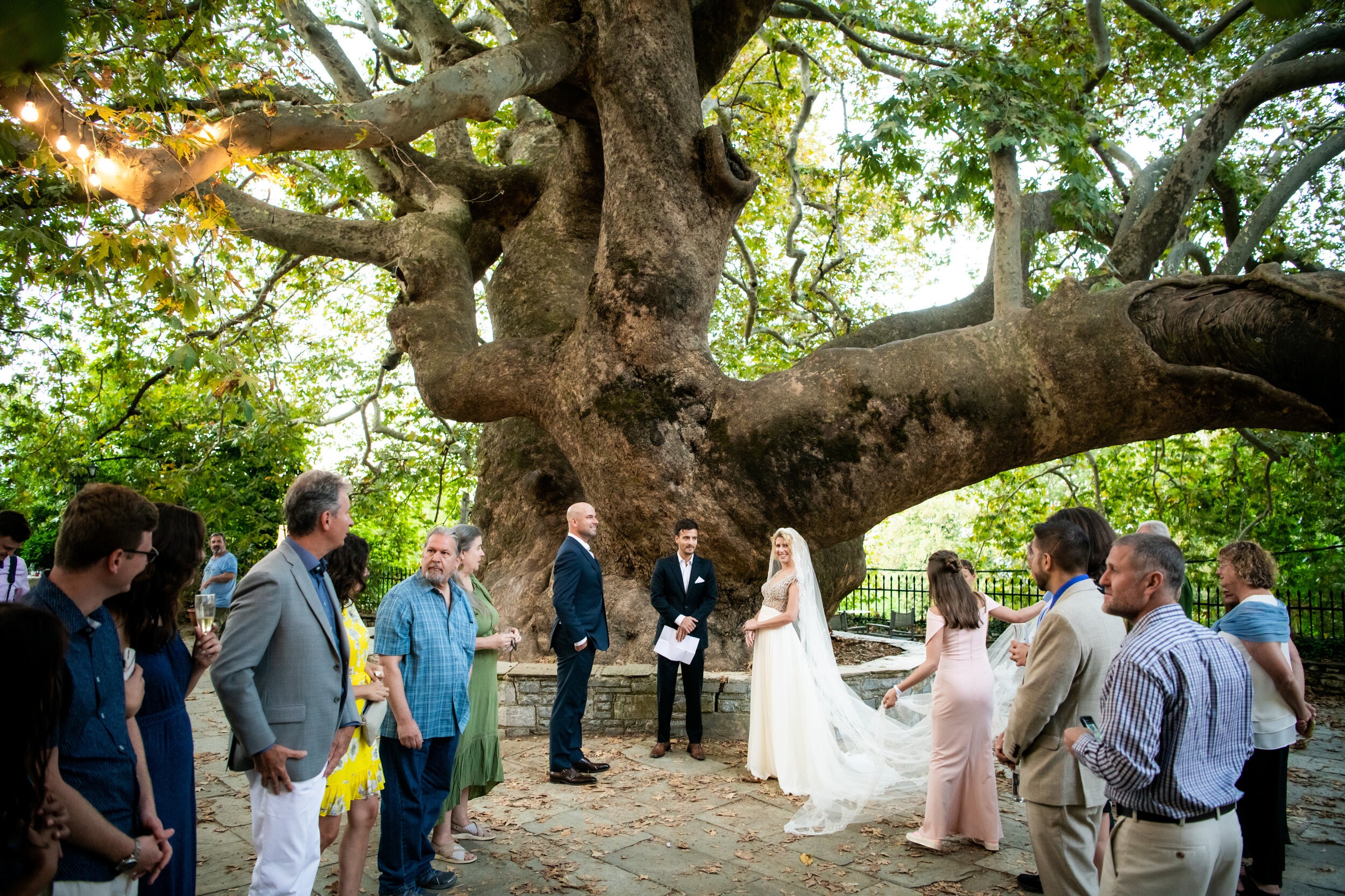 Wedding ceremony under a plane tree in Greece:  destination wedding photo at the Lost Unicorn Hotel, Tsagarada, Greece by J. Brown Photography.