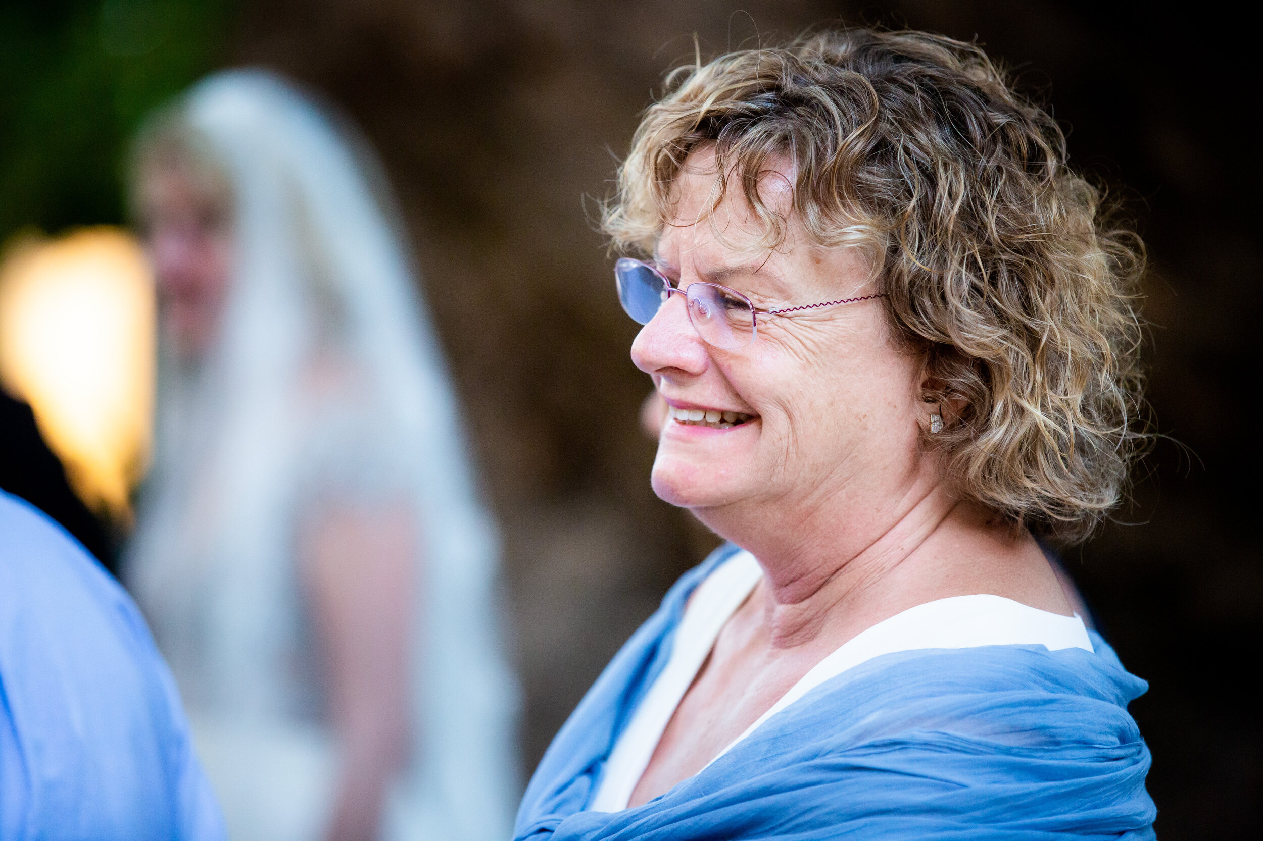 Mother of the groom smiles during her son's wedding ceremony:  destination wedding photo at the Lost Unicorn Hotel, Tsagarada, Greece by J. Brown Photography.