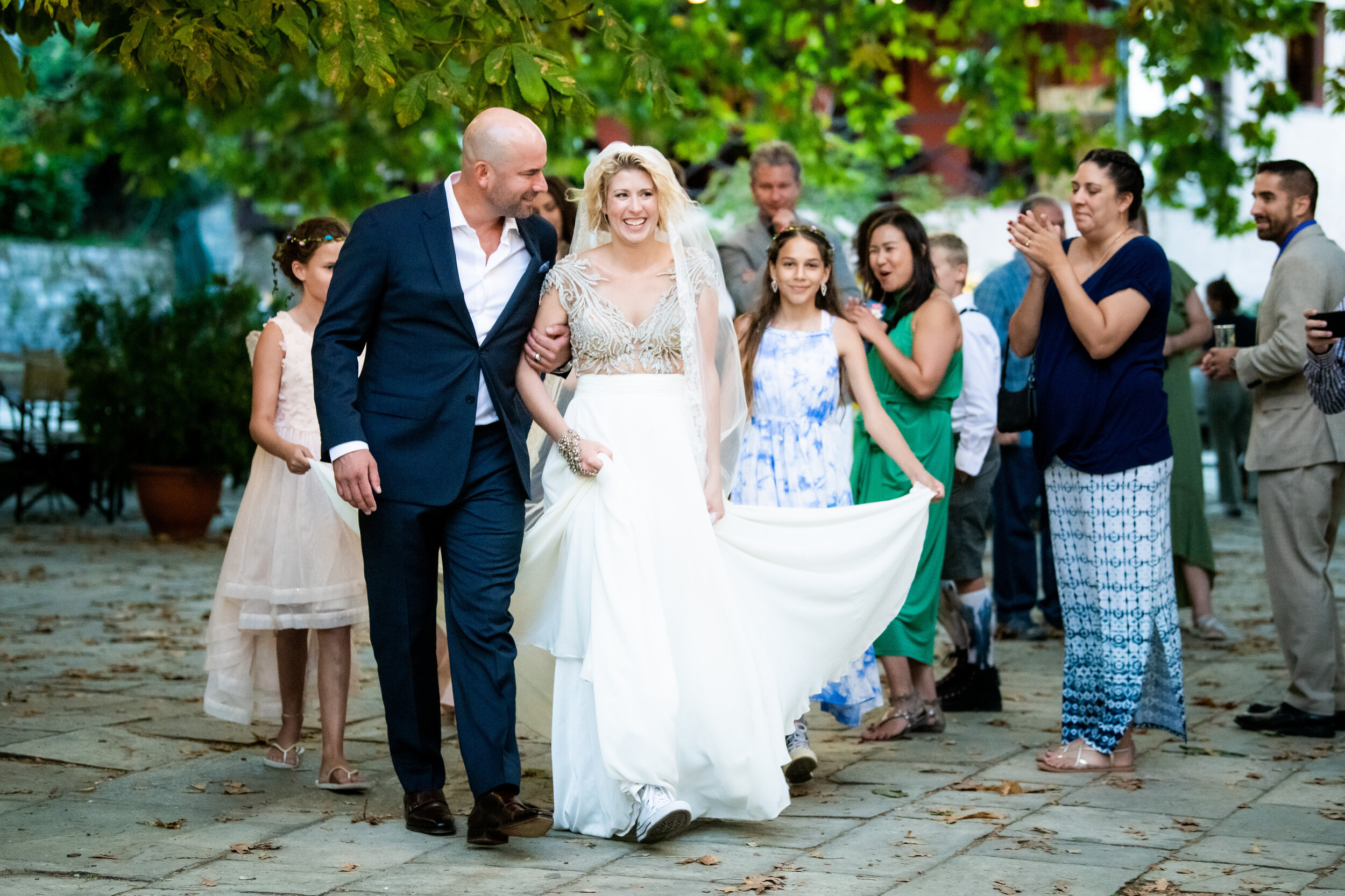 The newly weds and family process from ceremony:  destination wedding photo at the Lost Unicorn Hotel, Tsagarada, Greece by J. Brown Photography.