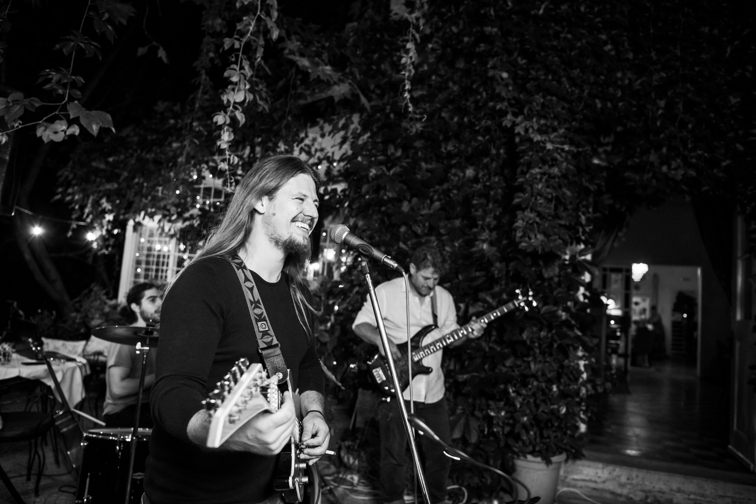 Band plays during an outdoor wedding reception:  destination wedding photo at the Lost Unicorn Hotel, Tsagarada, Greece by J. Brown Photography.