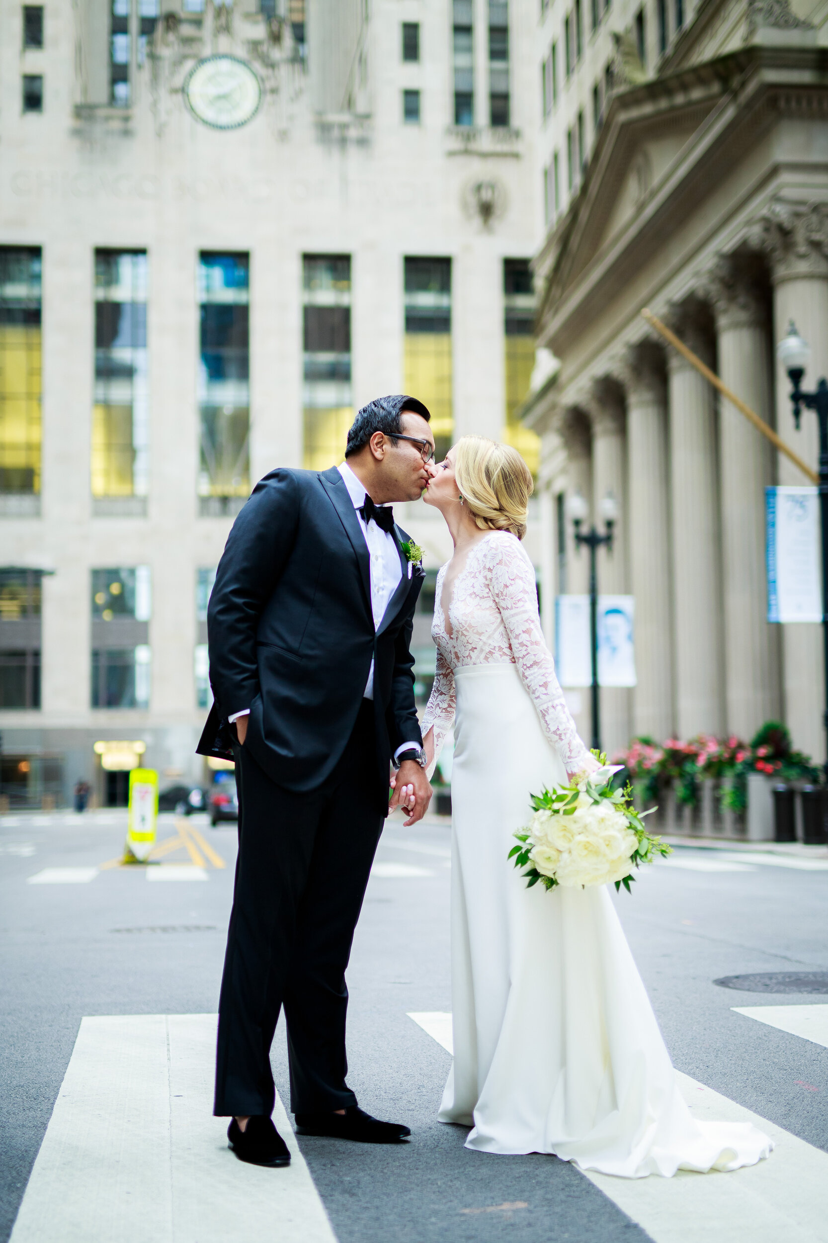 Bride and groom photo outside the Board of Trade: Geraghty Chicago wedding photography captured by J. Brown Photography.