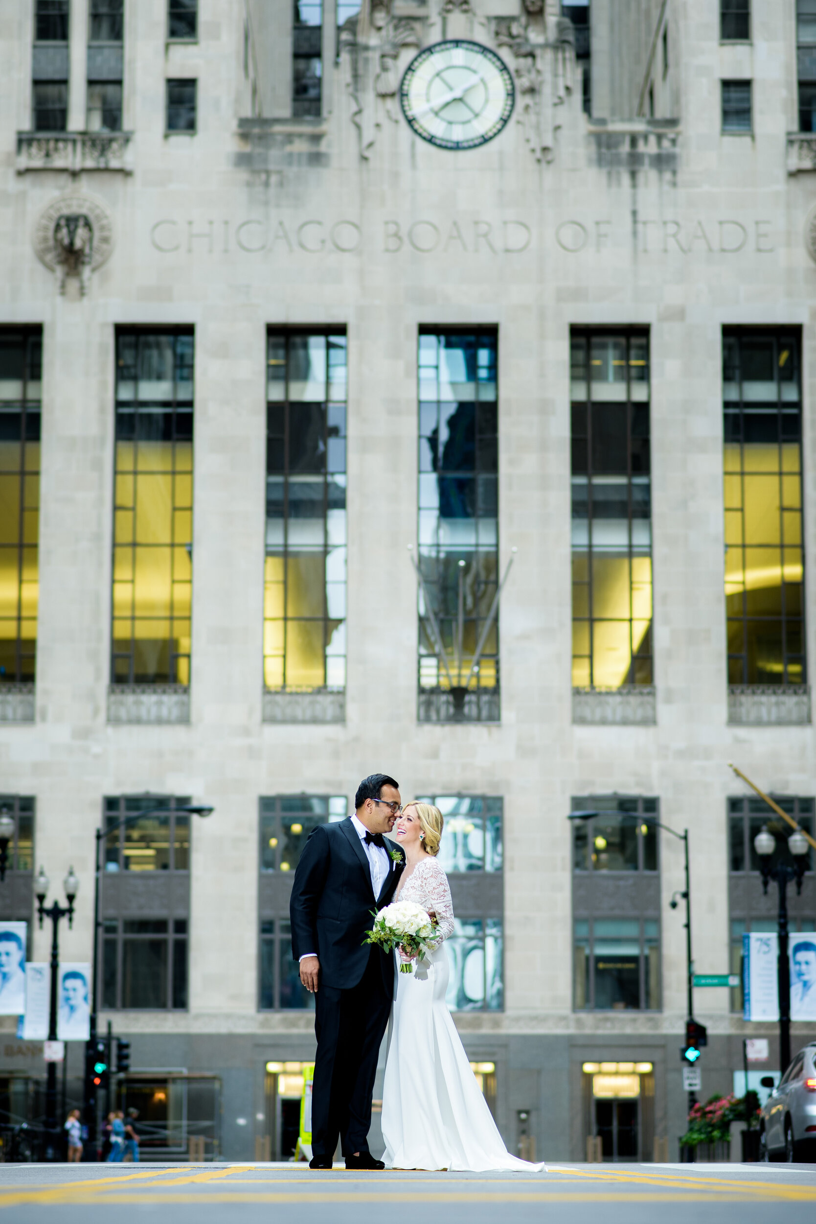 Wedding portrait of the couple outside the Board of Trade: Geraghty Chicago wedding photography captured by J. Brown Photography.