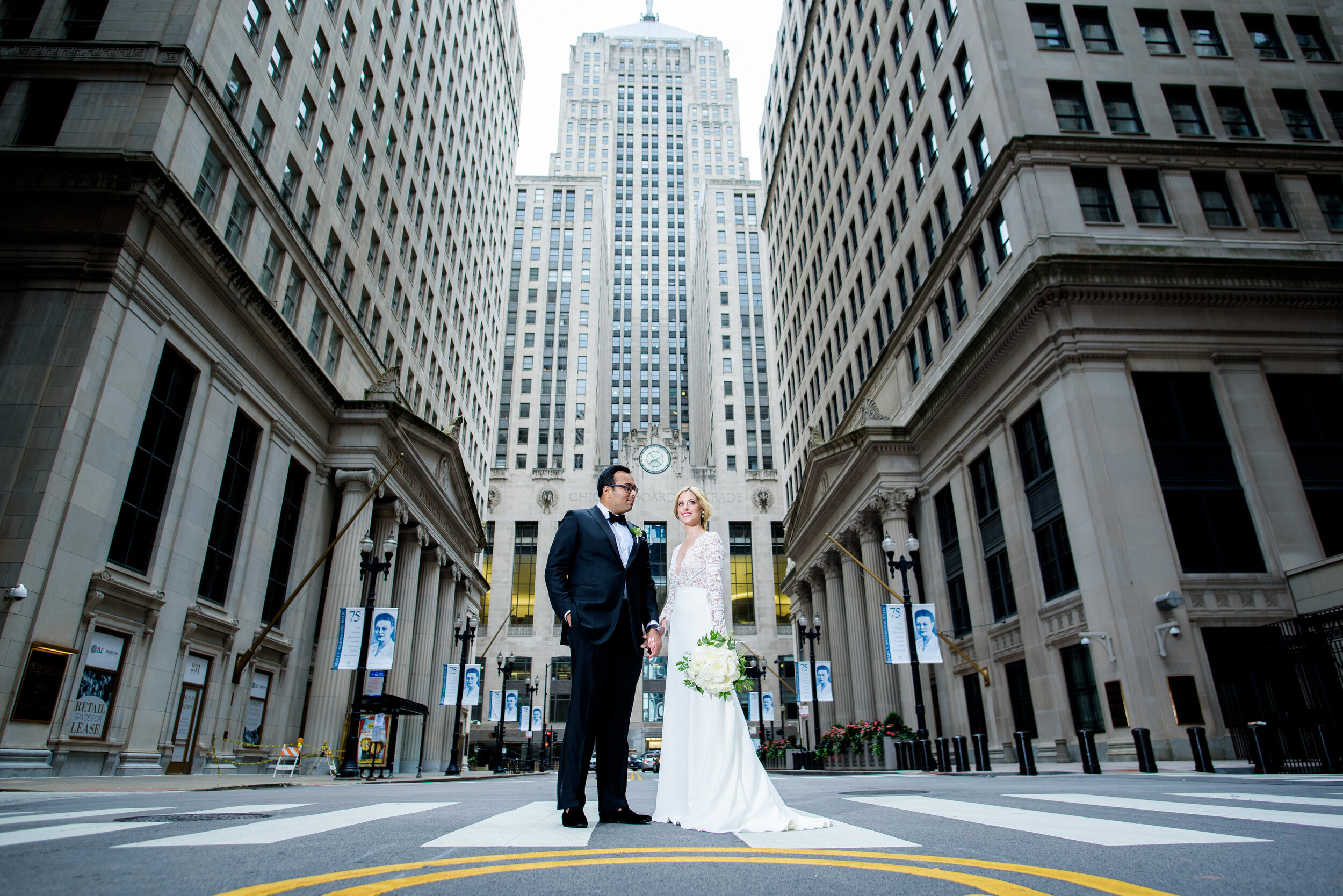 Bride and groom portrait outside the Board of Trade: Geraghty Chicago wedding photography captured by J. Brown Photography.