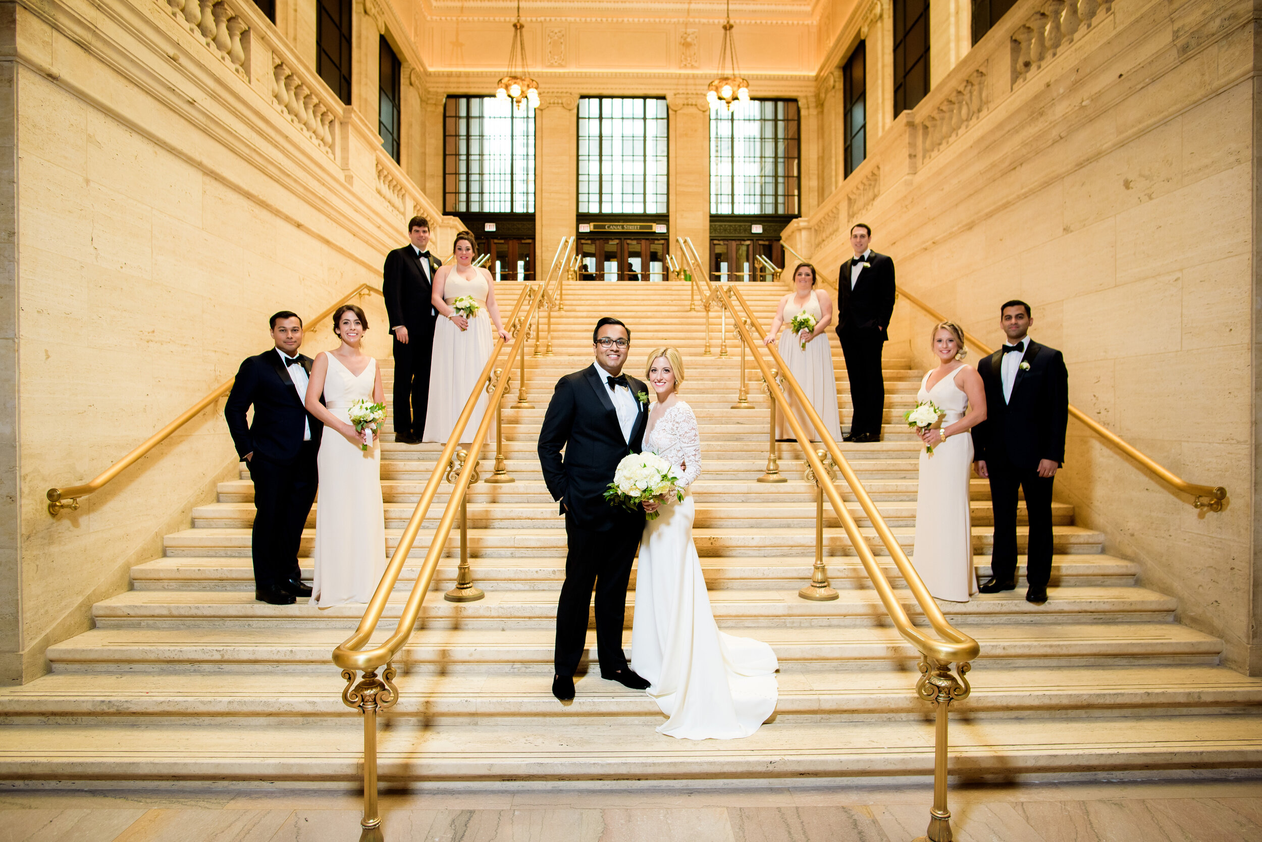 Wedding party portrait on grand staircase at Chicago Union Station: Geraghty Chicago wedding photography captured by J. Brown Photography.