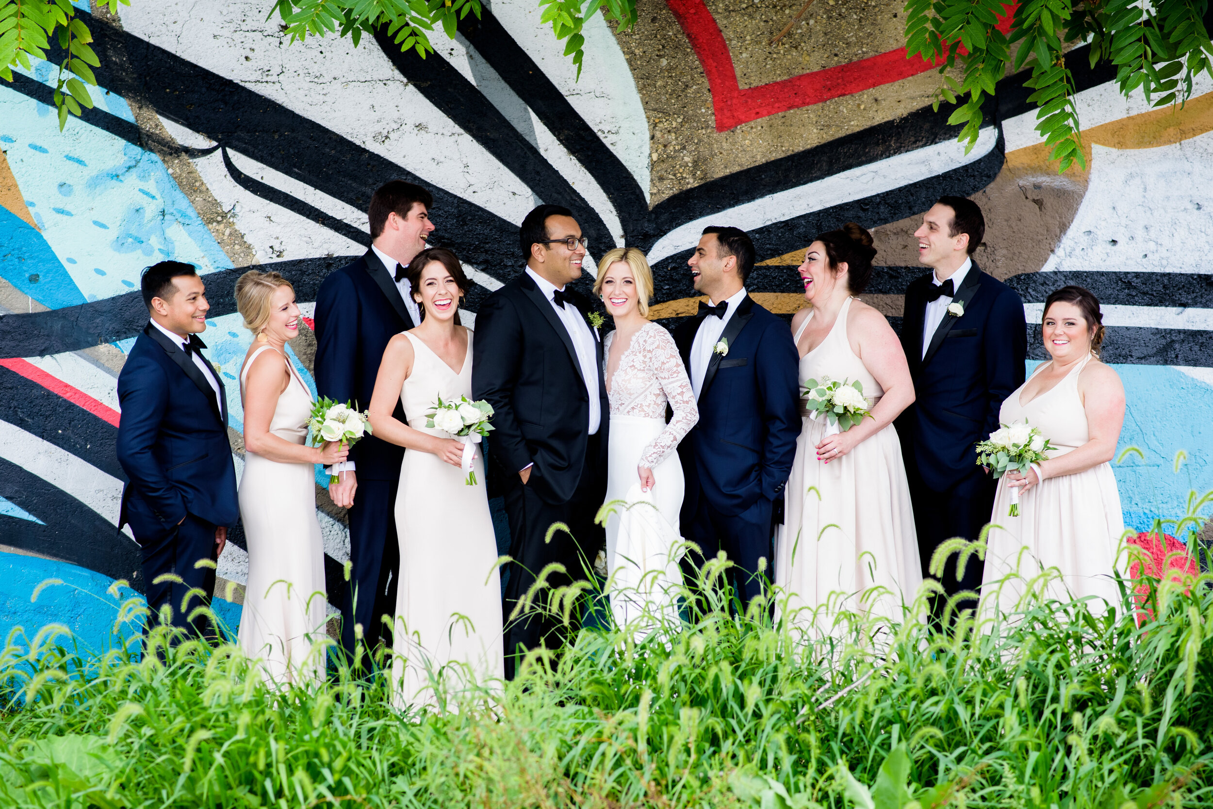 Fun wedding party portrait with street art mural in Pilsen: Geraghty Chicago wedding photography captured by J. Brown Photography.