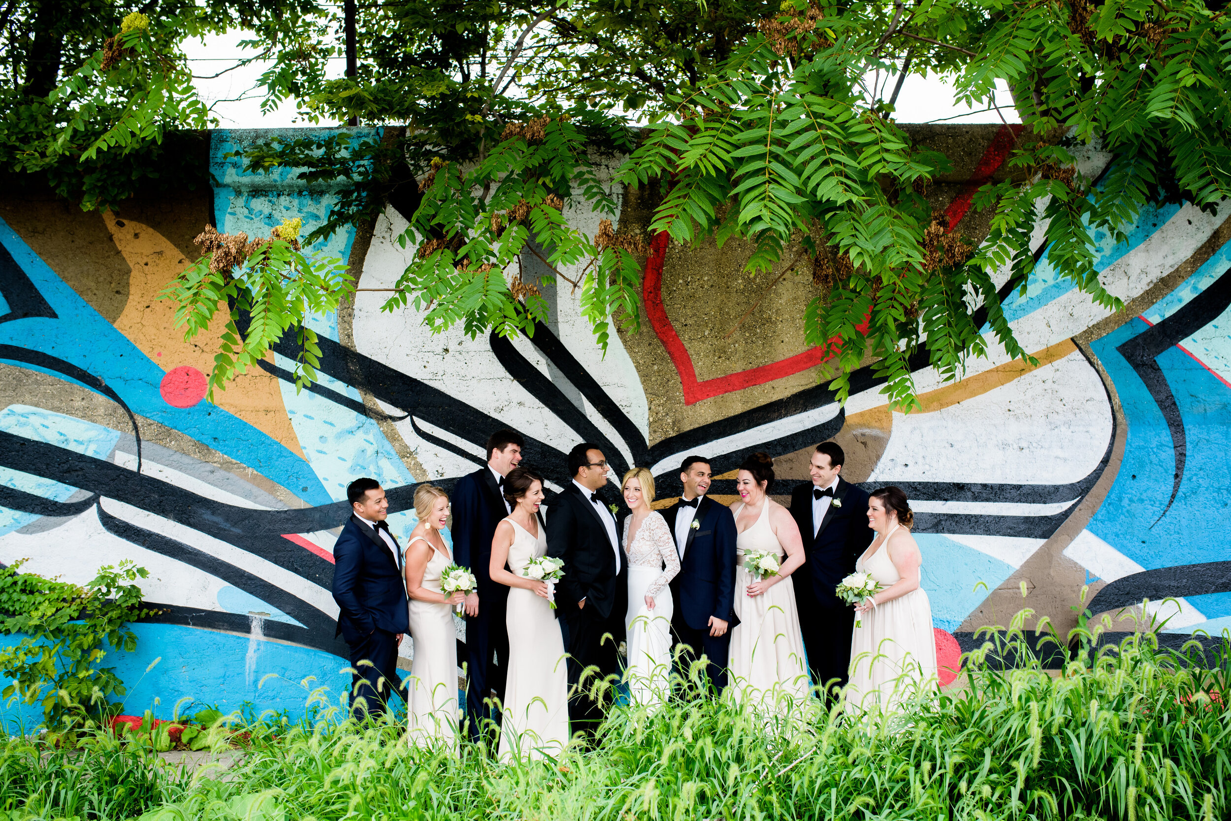 Creative wedding party photo with street art in Pilsen: Geraghty Chicago wedding photography captured by J. Brown Photography.