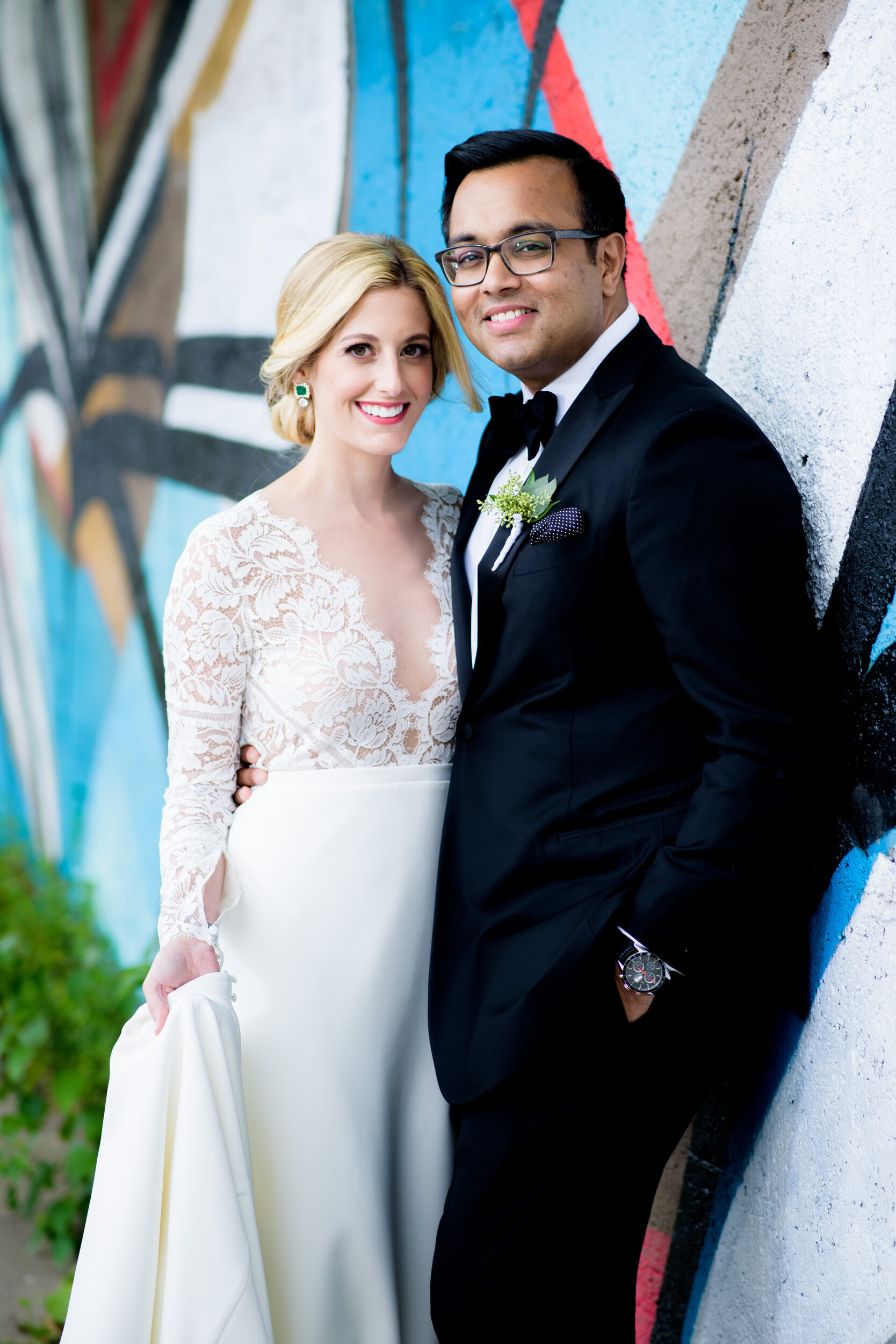 Wedding portrait of the couple with Pilsen street art: Geraghty Chicago wedding photography captured by J. Brown Photography.