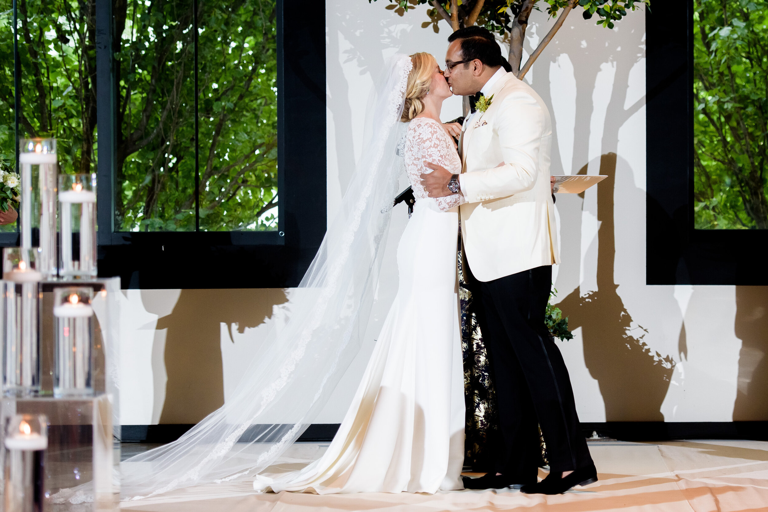 First kiss during the wedding ceremony: Geraghty Chicago wedding photography captured by J. Brown Photography.
