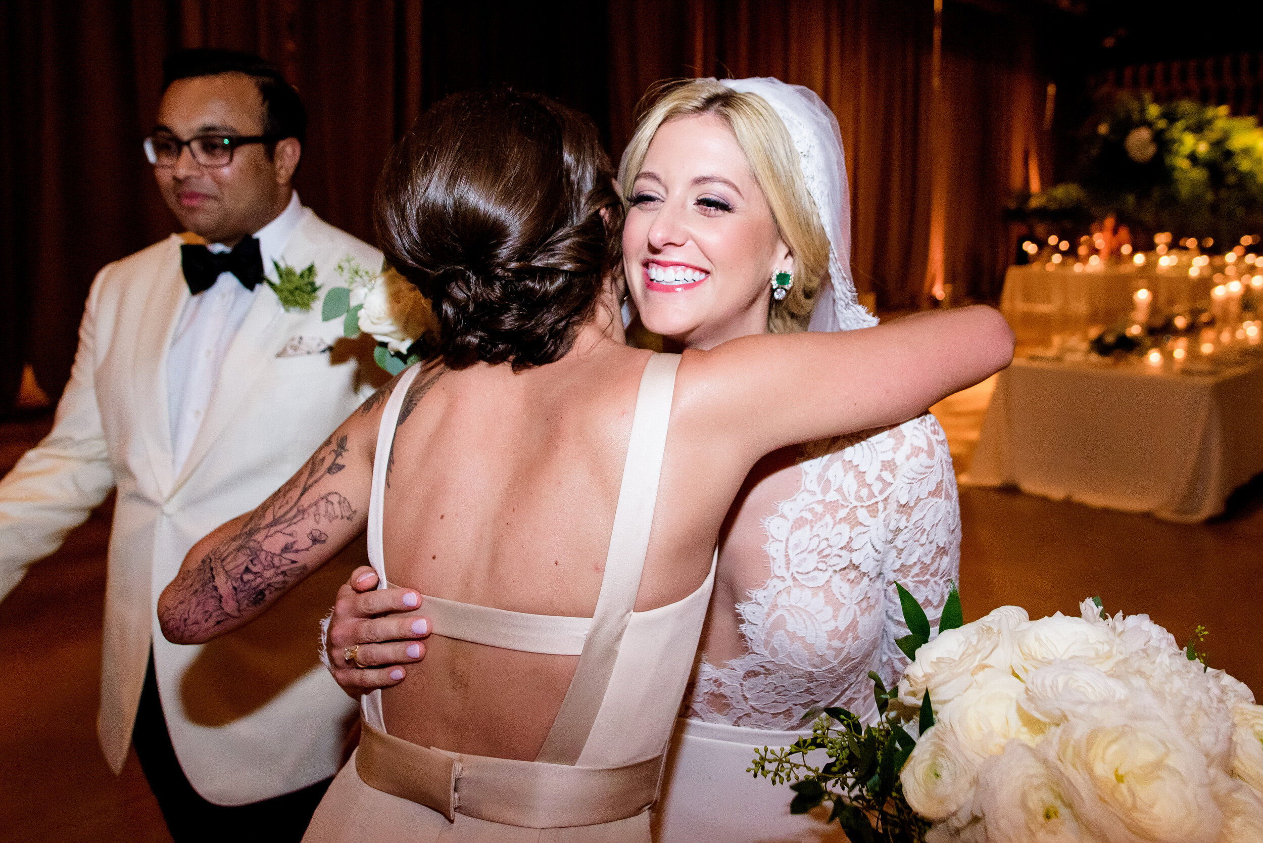 Bride hugs her sister after the ceremony: Geraghty Chicago wedding photography captured by J. Brown Photography.
