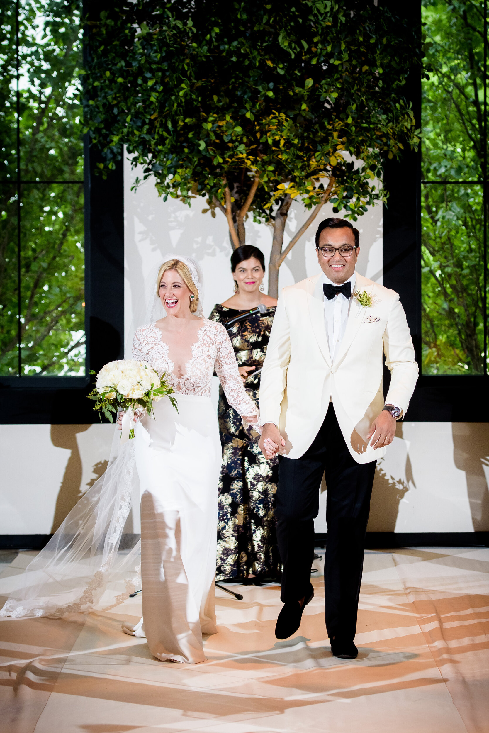 Bride and groom walk down the aisle: Geraghty Chicago wedding photography captured by J. Brown Photography.