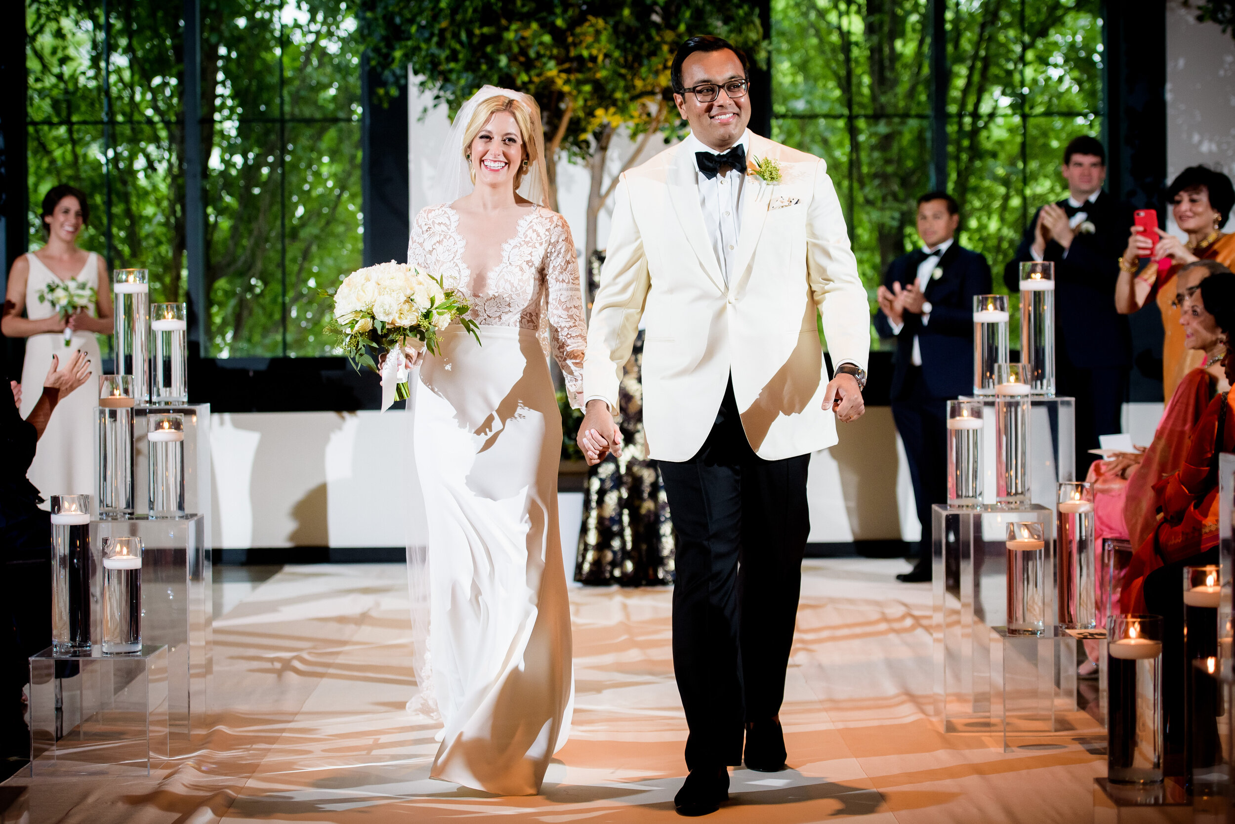 Newly weds walk down the aisle: Geraghty Chicago wedding photography captured by J. Brown Photography.