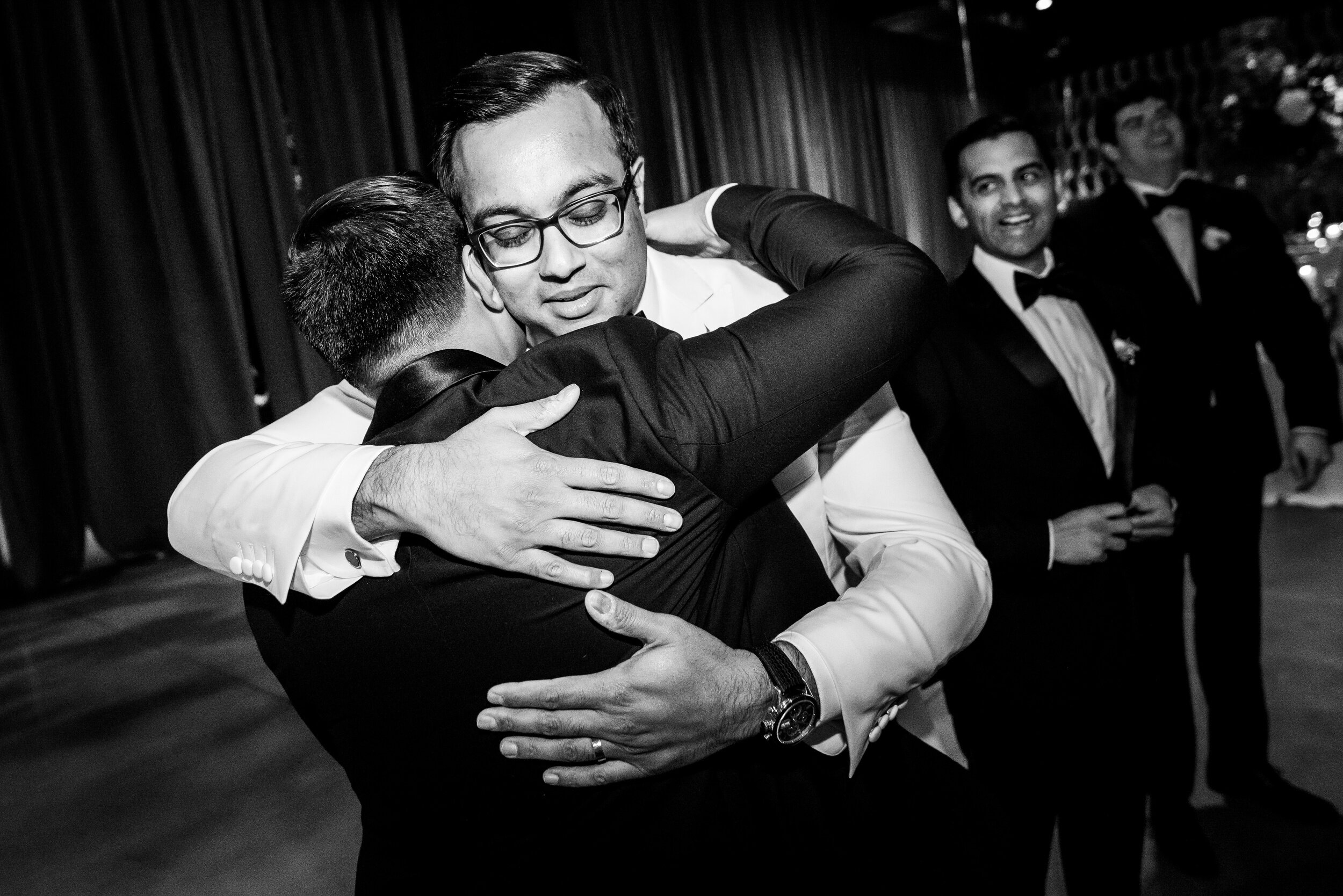 Groom hugs the best man: Geraghty Chicago wedding photography captured by J. Brown Photography.