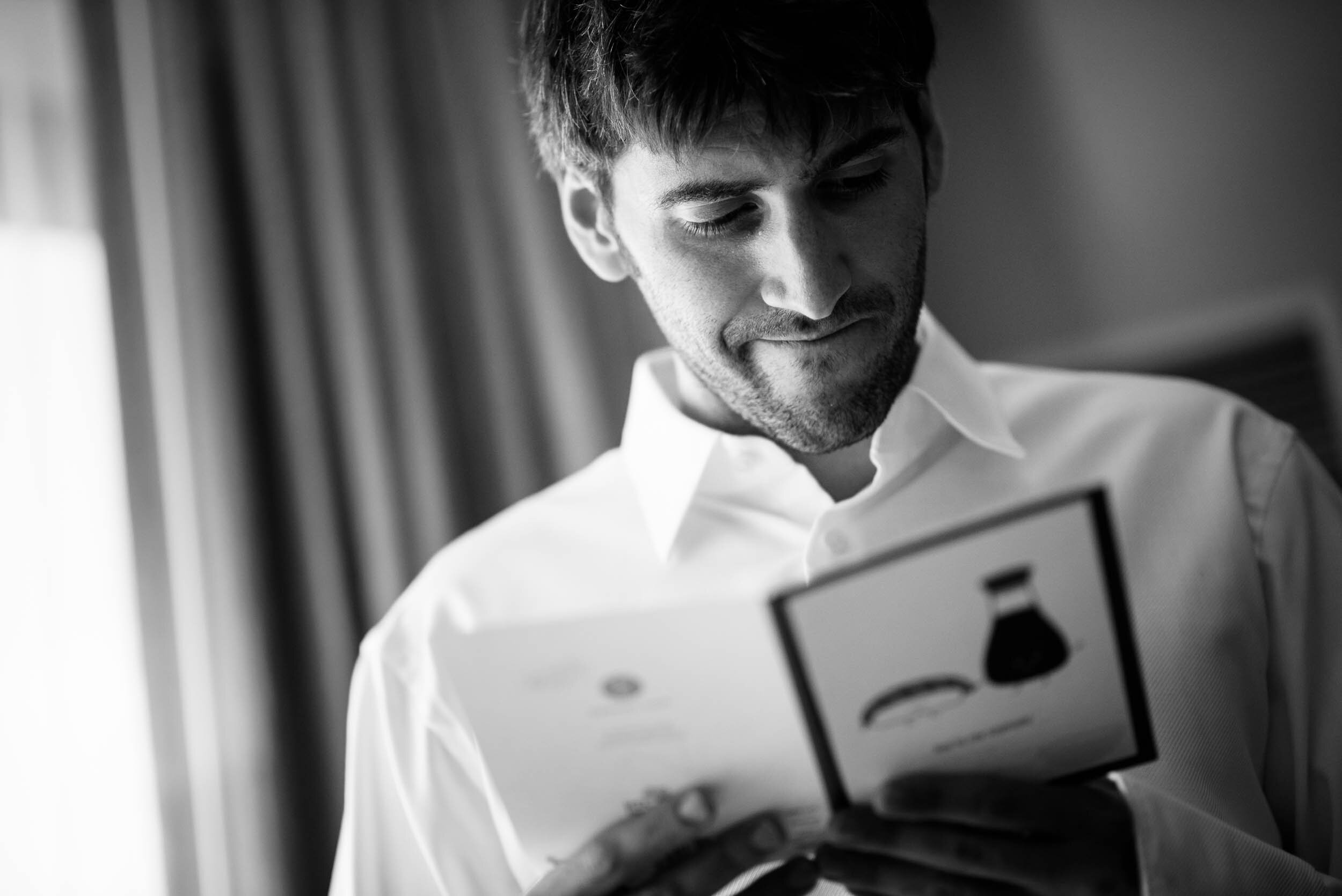 Groom reads a card from the bride: Ravenswood Event Center Chicago wedding captured by J. Brown Photography.  