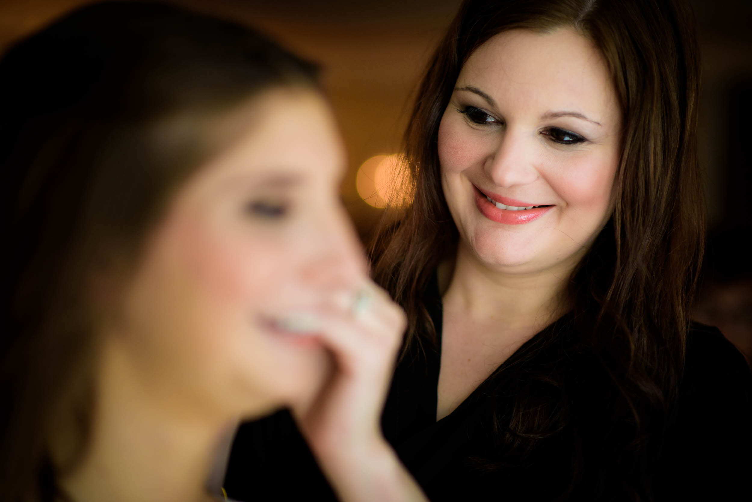 Maid of honor helping the bride get ready: Ravenswood Event Center Chicago wedding captured by J. Brown Photography.  