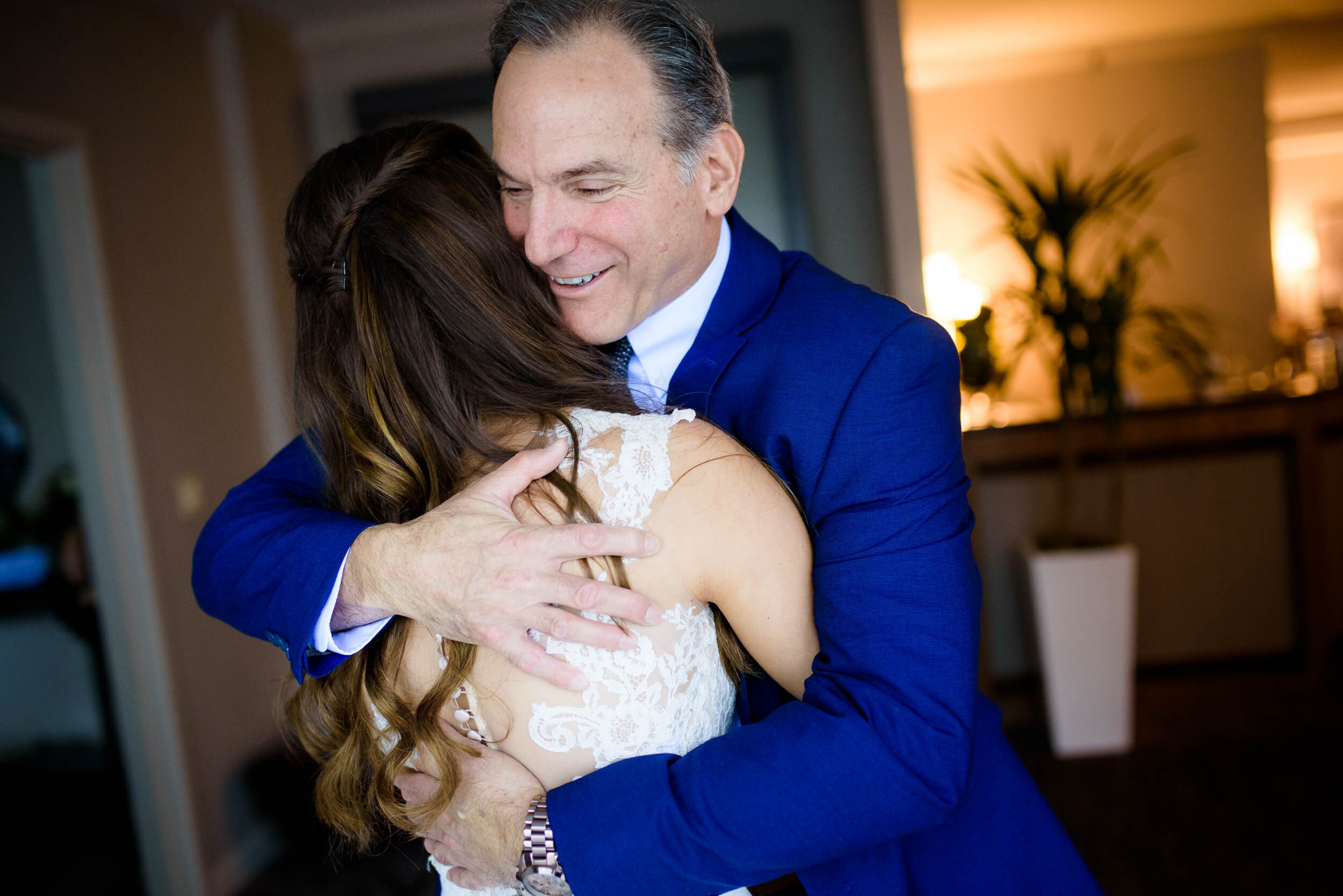 Father and daughter hug while getting ready on the wedding day: Ravenswood Event Center Chicago wedding captured by J. Brown Photography.  