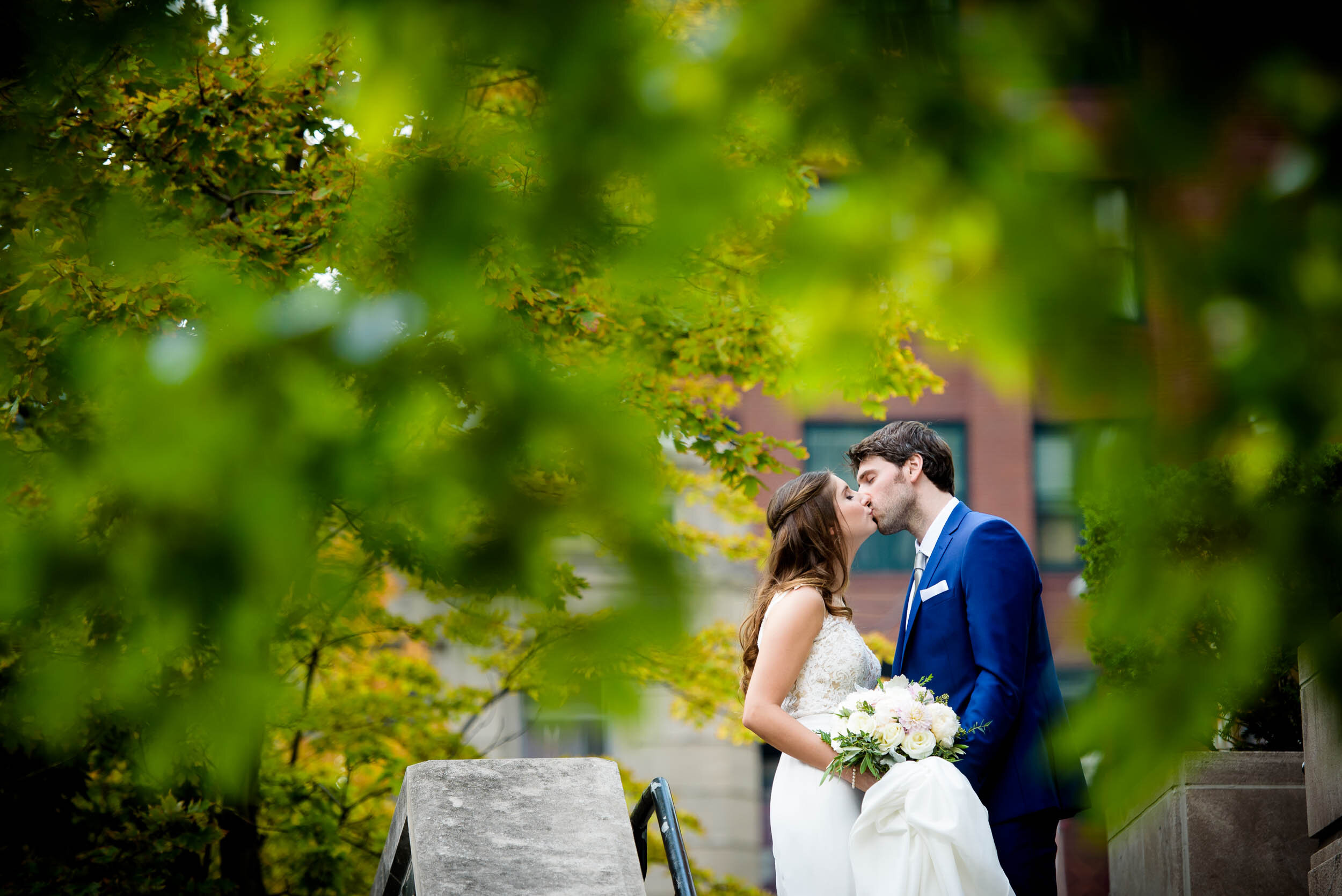 Fun wedding day portrait of bride and groom kissing: Ravenswood Event Center Chicago wedding captured by J. Brown Photography.  