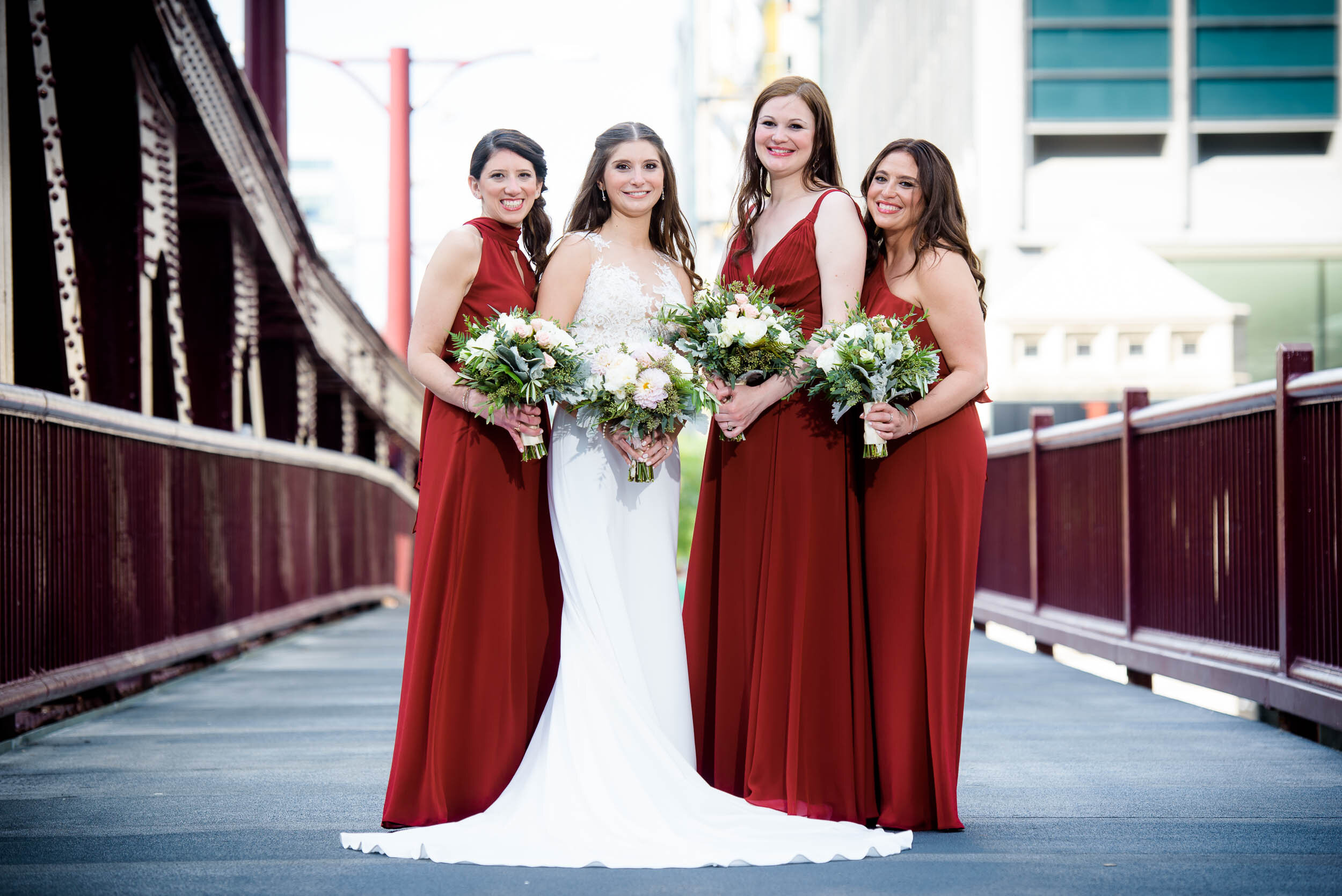 Bride with bridesmaids portrait on the Chicago River bridge: Ravenswood Event Center Chicago wedding captured by J. Brown Photography.  