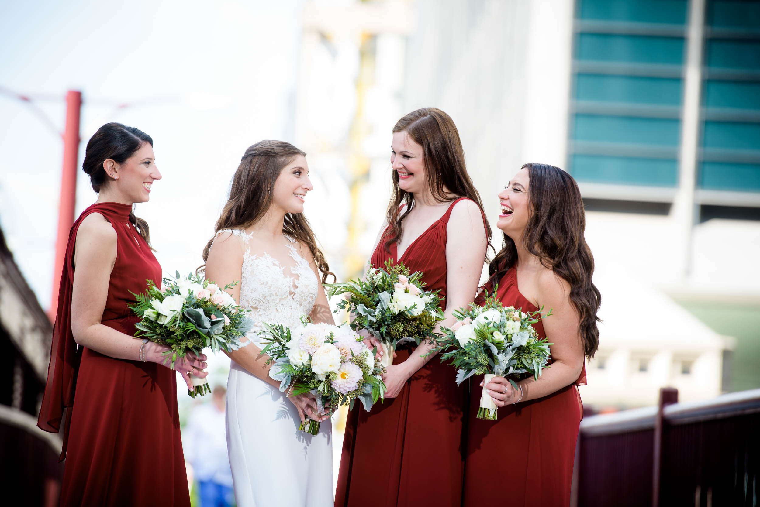 Bride laughs with her bridesmaids on the wedding day: Ravenswood Event Center Chicago wedding captured by J. Brown Photography.  