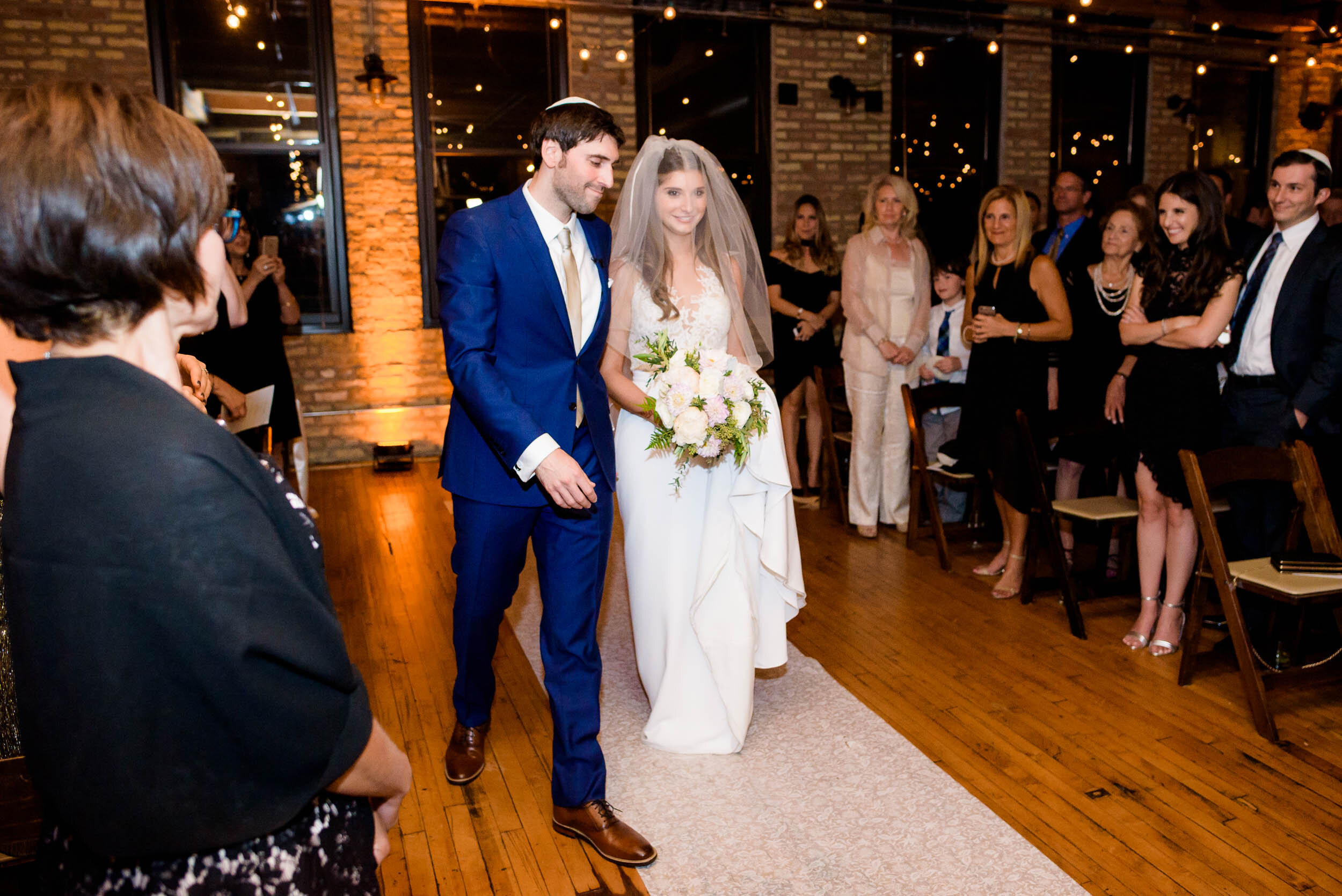 Bride and groom during a Jewish ceremony: Ravenswood Event Center Chicago wedding captured by J. Brown Photography.  