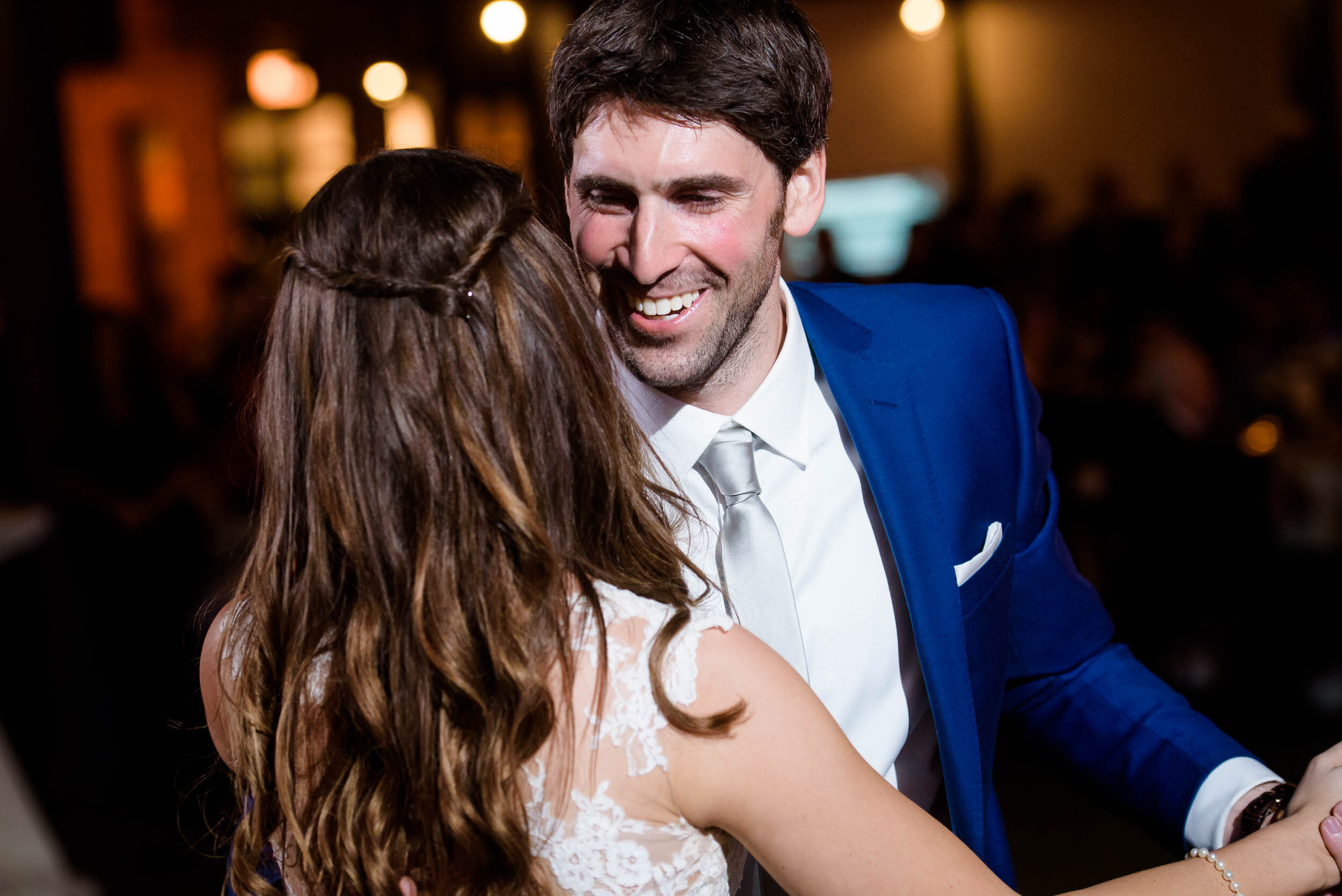 Groom smiles during the first dance: Ravenswood Event Center Chicago wedding captured by J. Brown Photography.  