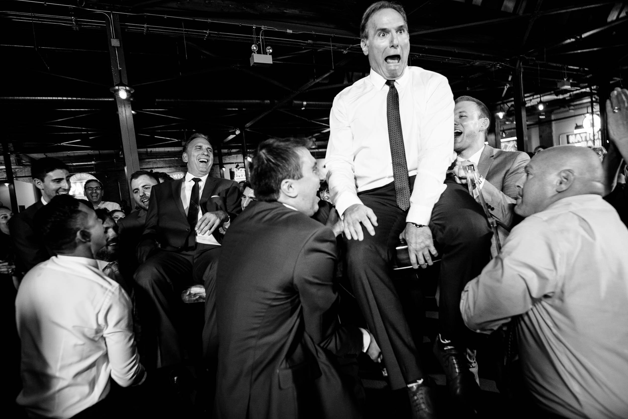 Fun photo of the dads during the horah: Ravenswood Event Center Chicago wedding captured by J. Brown Photography.  