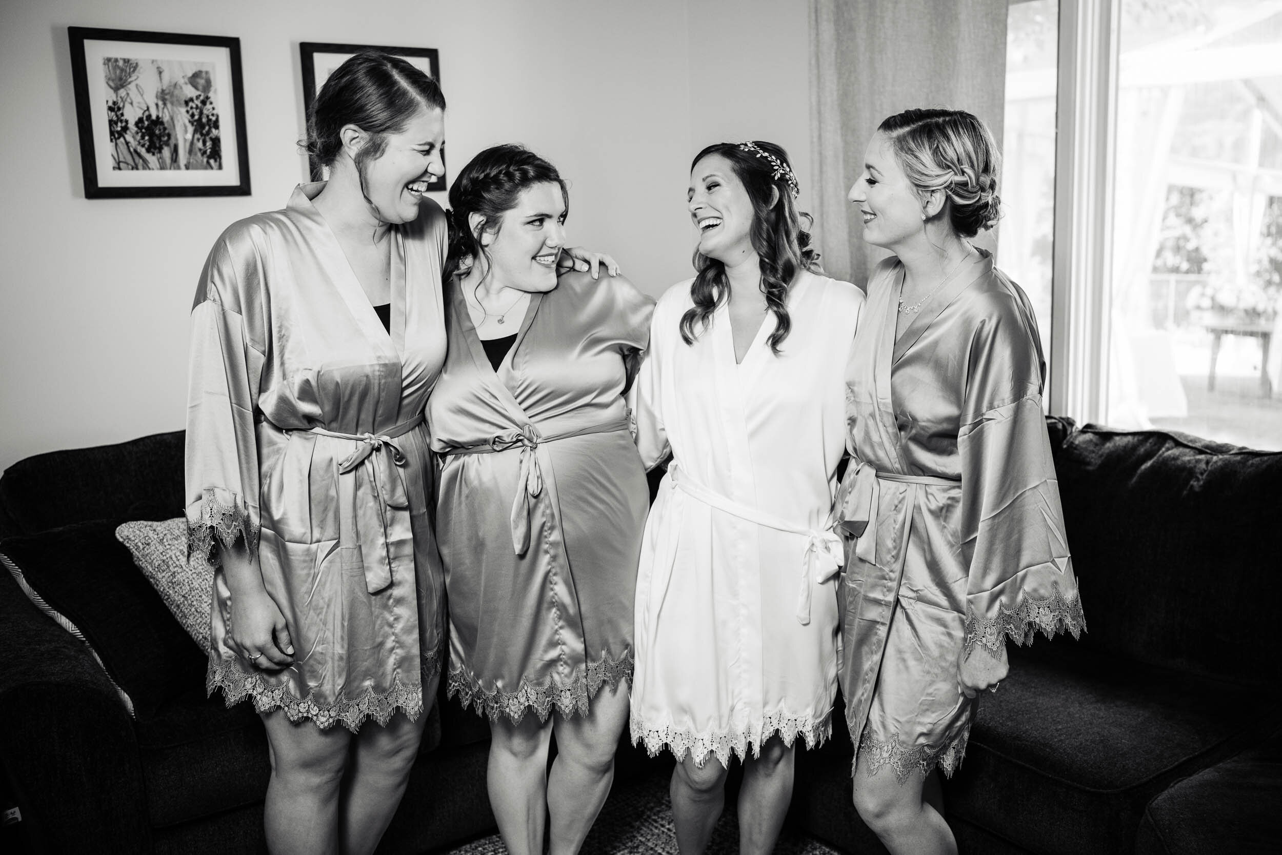 Candid moment with bride and bridesmaids:  Chicago backyard wedding photographed by J. Brown Photography.