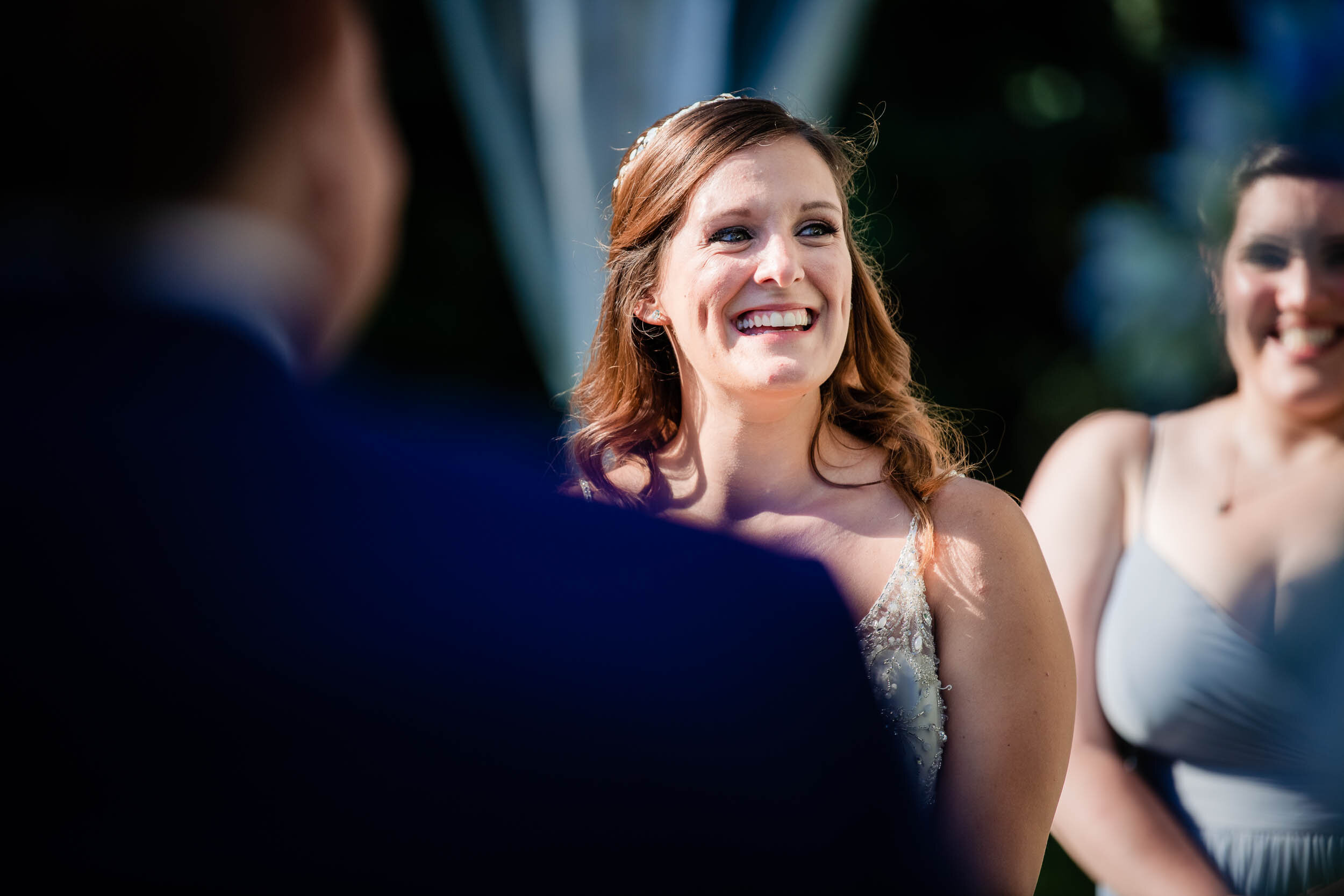 Bride laughs during the ceremony:  Chicago backyard wedding photographed by J. Brown Photography.