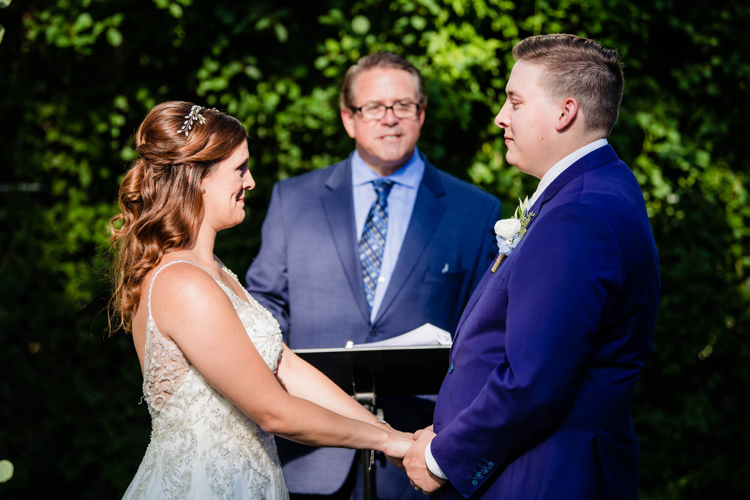 Bride and groom say their vows during their ceremony:  Chicago backyard wedding photographed by J. Brown Photography.