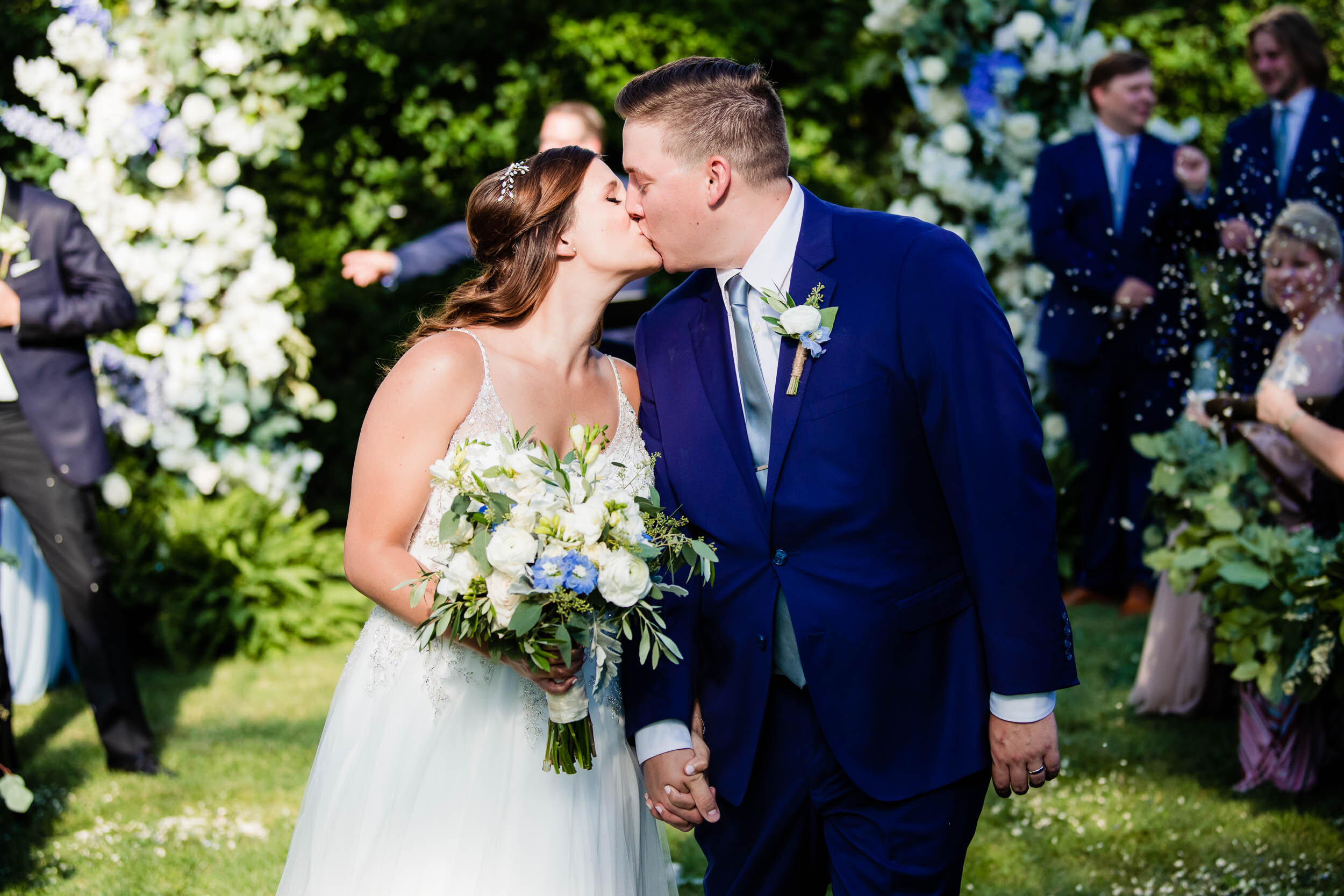 Bride and groom kiss after being married:  Chicago backyard wedding photographed by J. Brown Photography.