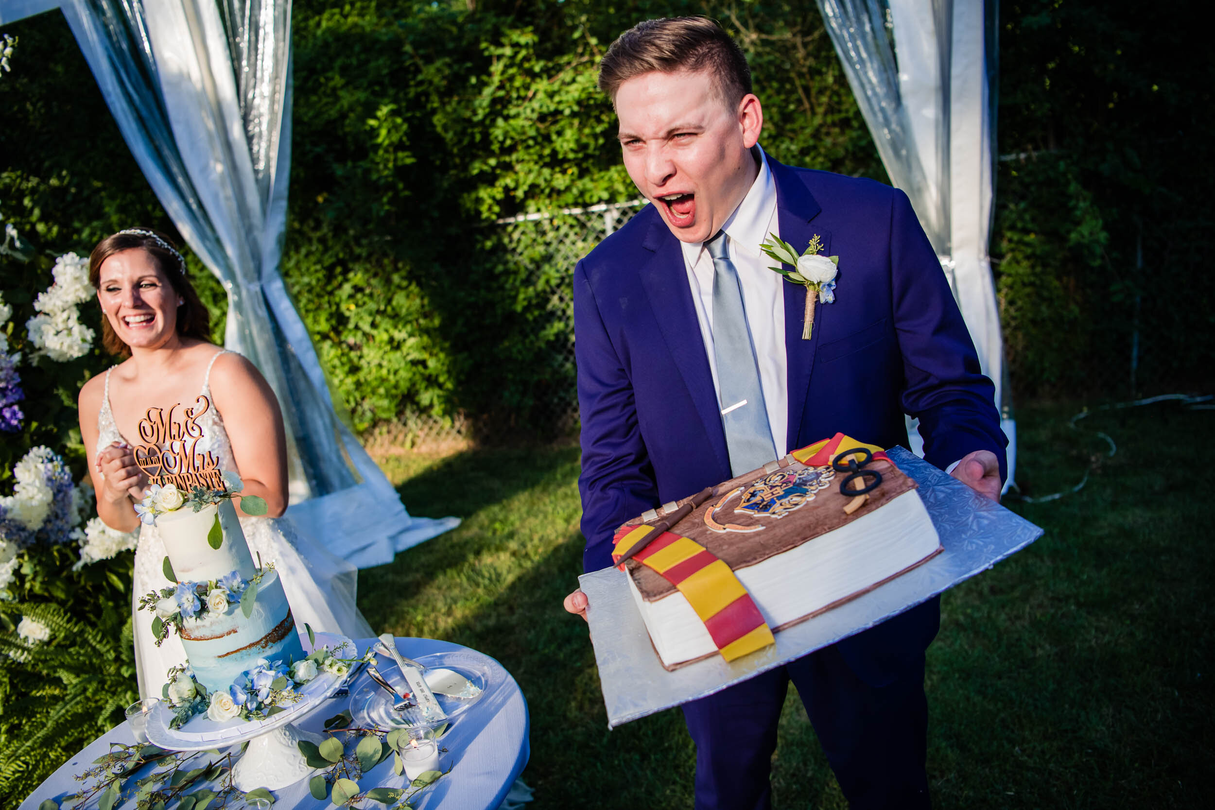 Groom receives a Harry Potter wedding cake:  Chicago backyard wedding photographed by J. Brown Photography.
