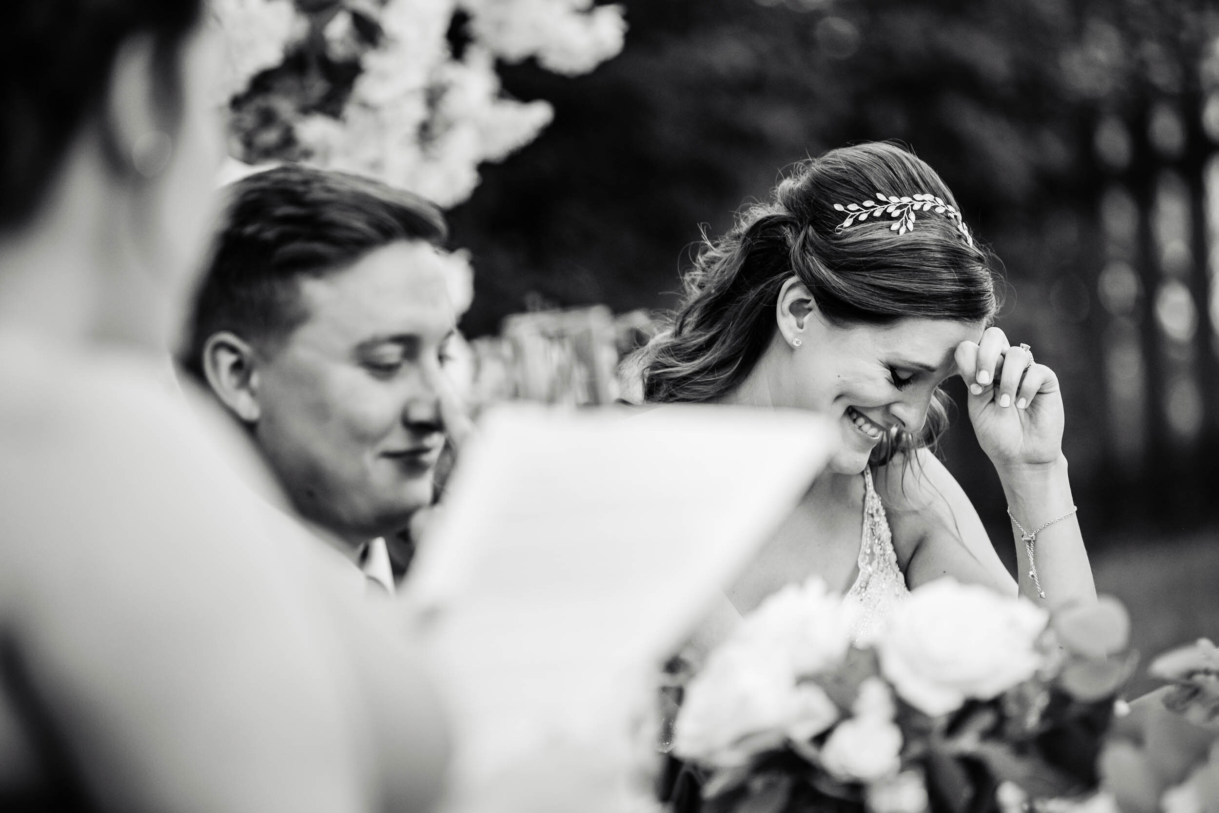 Bride reacts during the maid of honor toast:  Chicago backyard wedding photographed by J. Brown Photography.