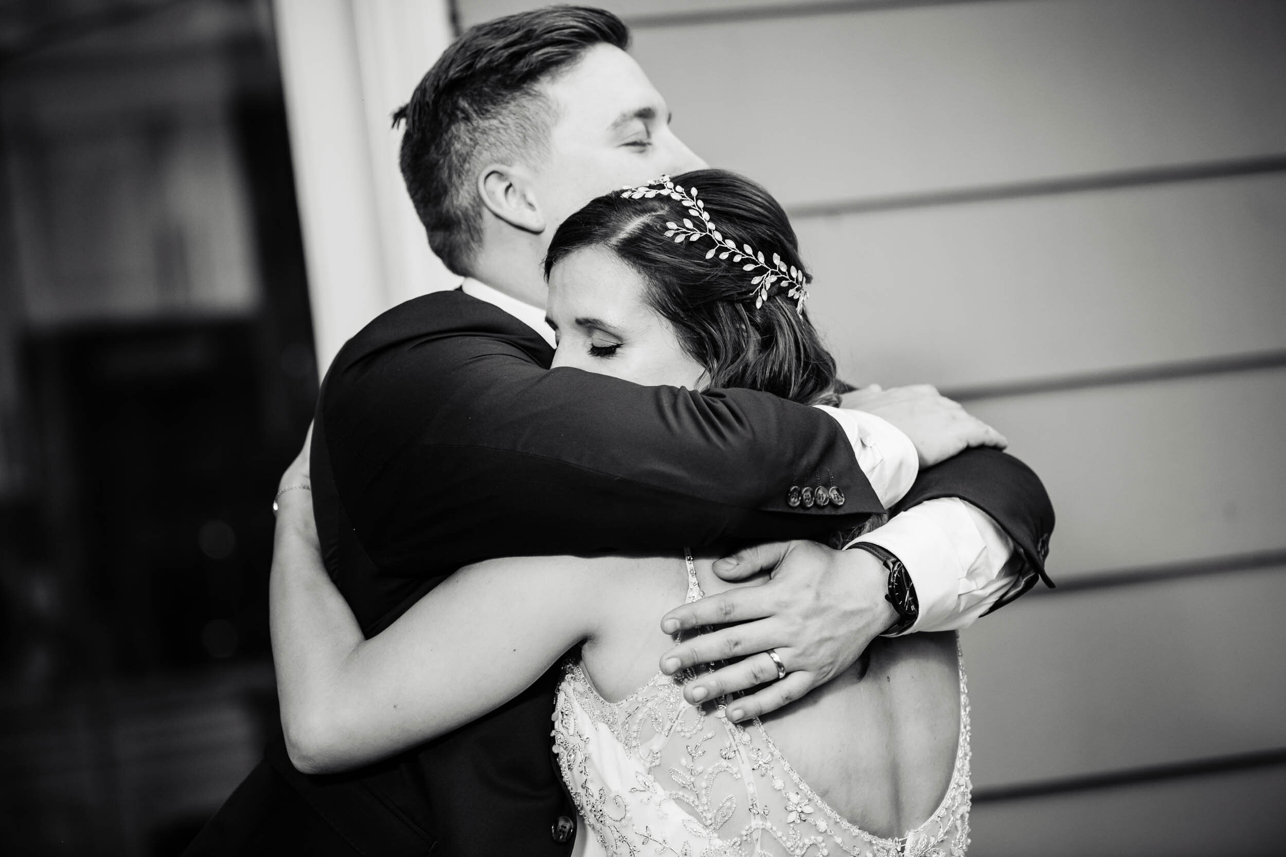 Bride and groom hug during their first dance:  Chicago backyard wedding photographed by J. Brown Photography.