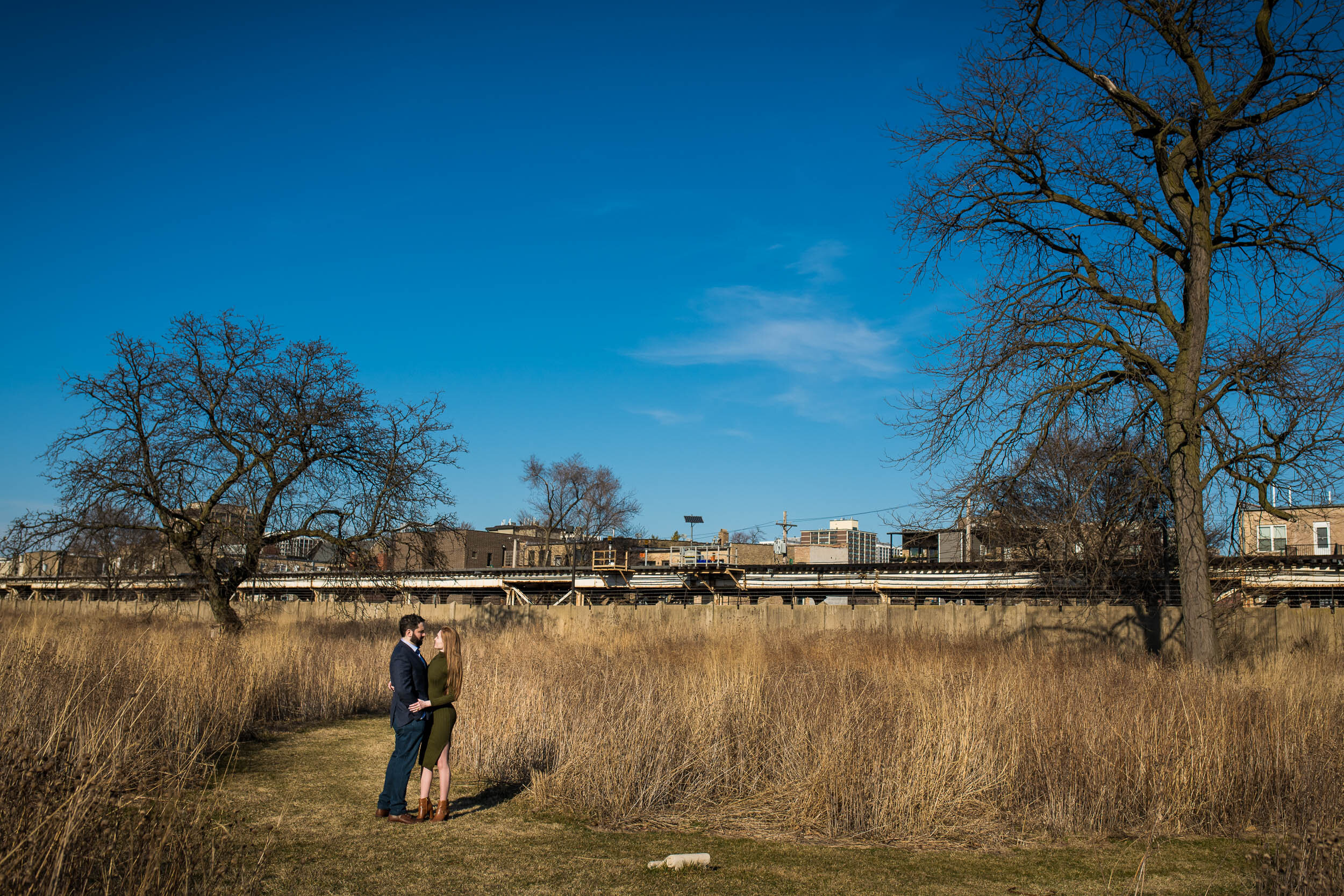 Sunny day photo of the couple at Graceland Cemetery:  Chicago engagement photo by J. Brown Photography.