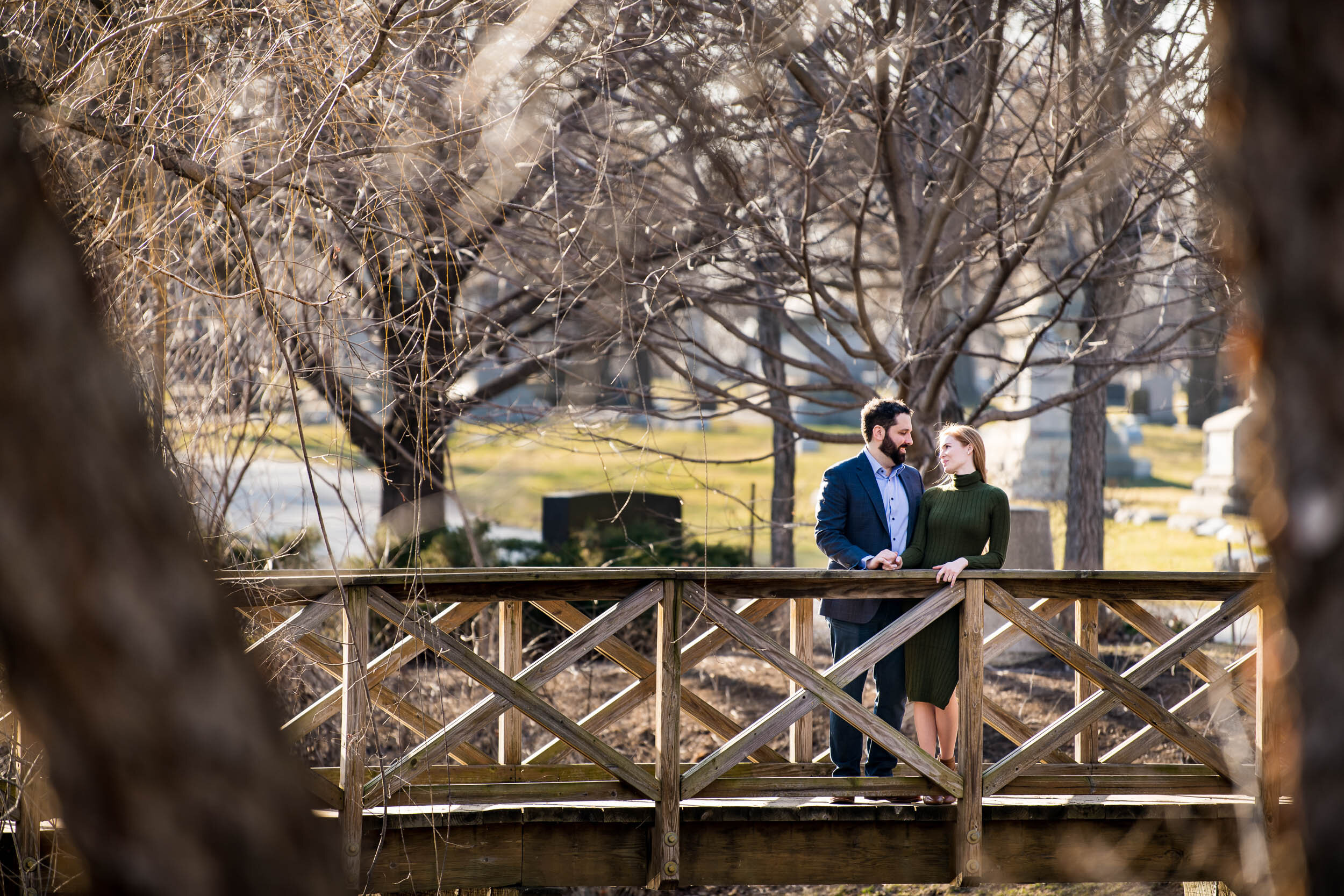 Couple's embrace at a bridge at Graceland Cemetery:  Chicago engagement photo by J. Brown Photography.