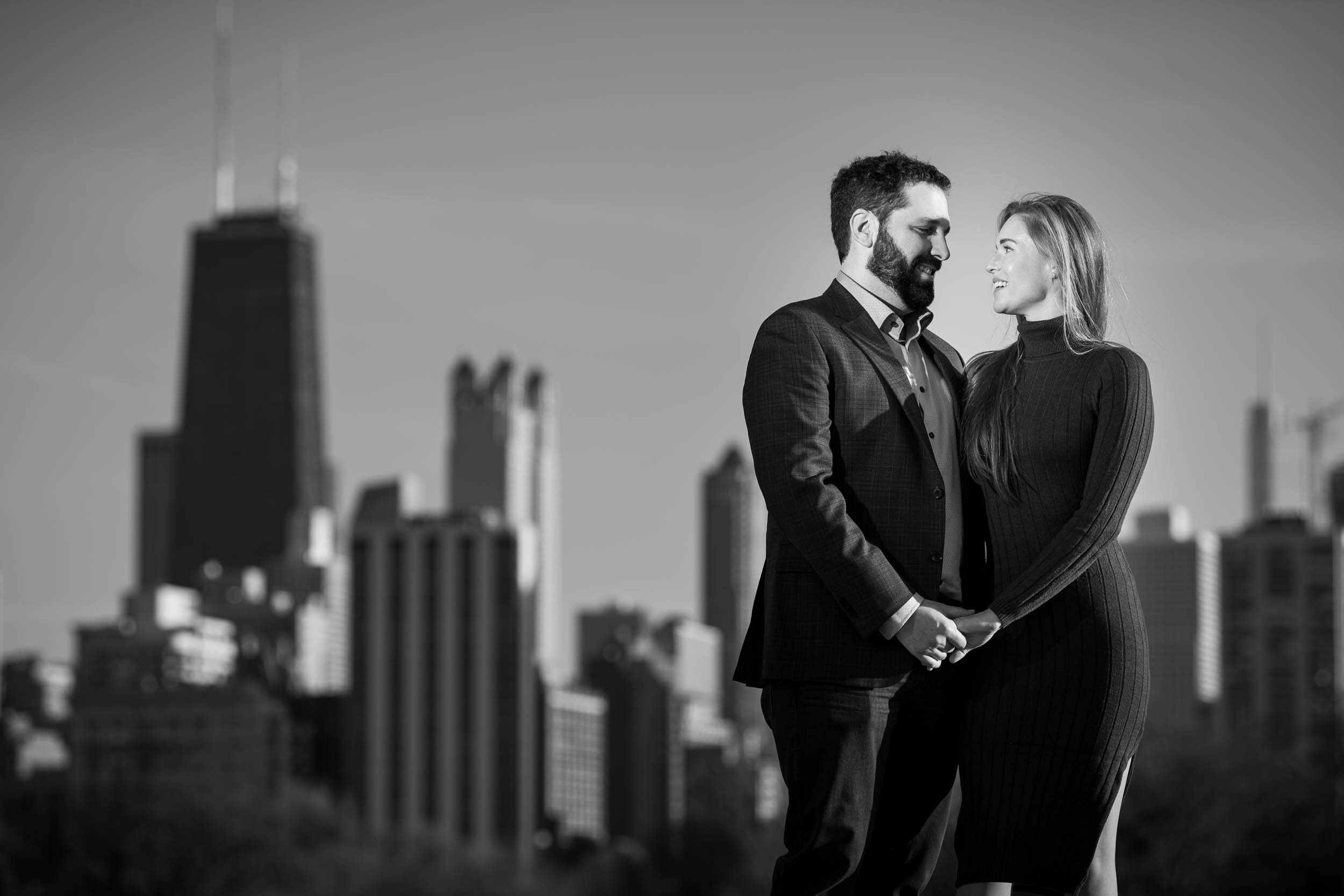 Couple with the skyline at Lincoln Park:  Chicago engagement photo by J. Brown Photography.
