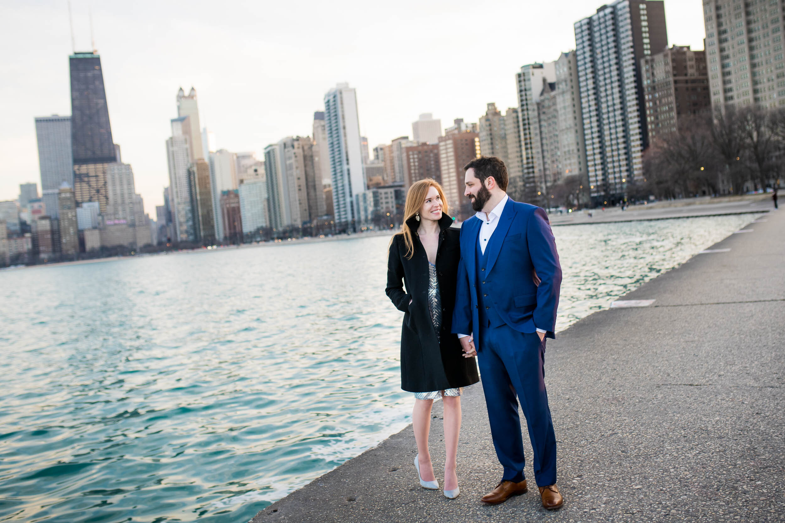Couple walks along the shore at North Avenue Beach:  Chicago engagement photo by J. Brown Photography.
