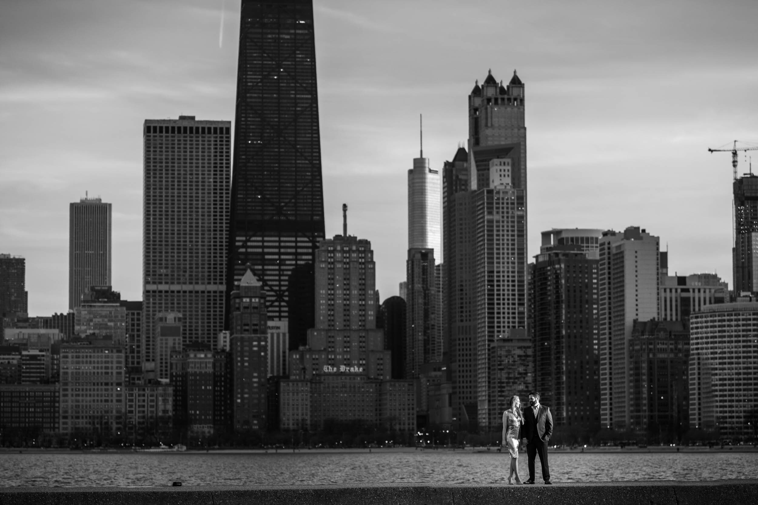 Photo of the couple with the skyline at North Avenue Beach:  Chicago engagement photo by J. Brown Photography.