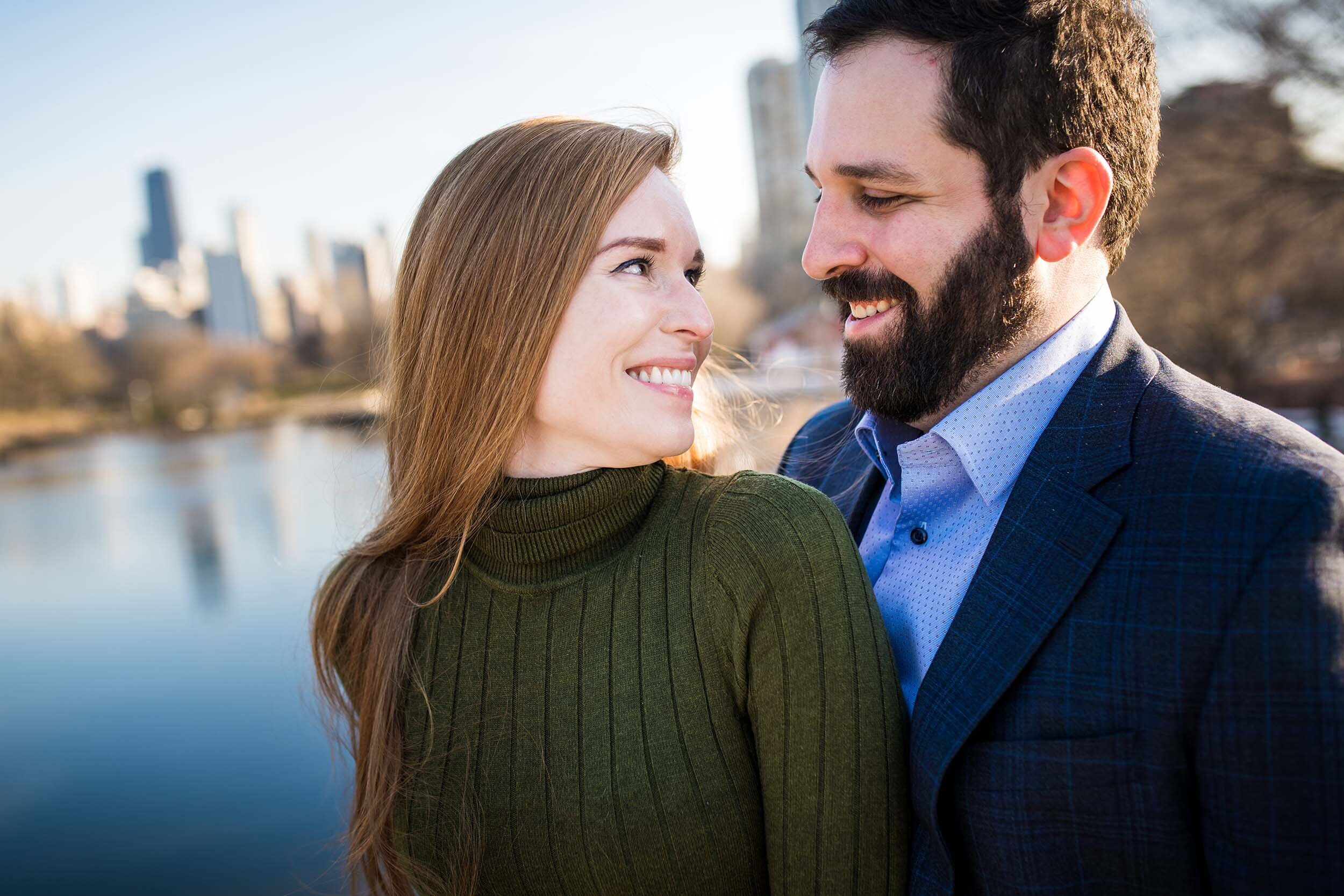 Couple with the skyline at Lincoln Park:  Chicago engagement photo by J. Brown Photography.