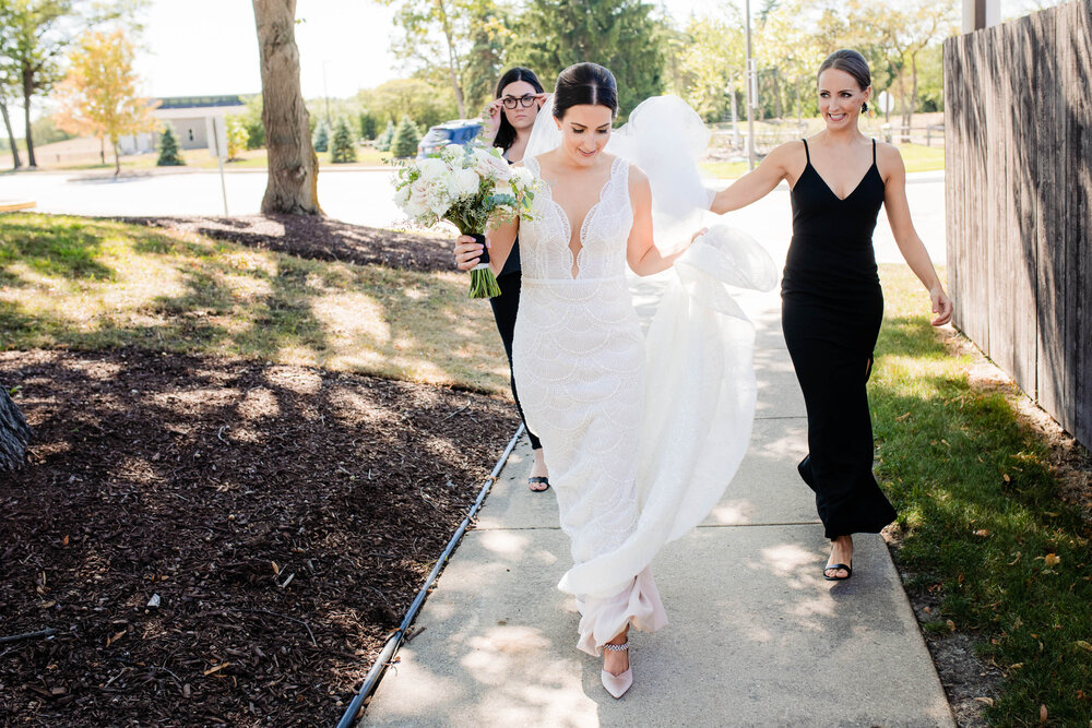 Bride makes her way to the first look at the Oakbrook Bath &amp; Tennis Club:  Chicago wedding photography by J. Brown Photography.