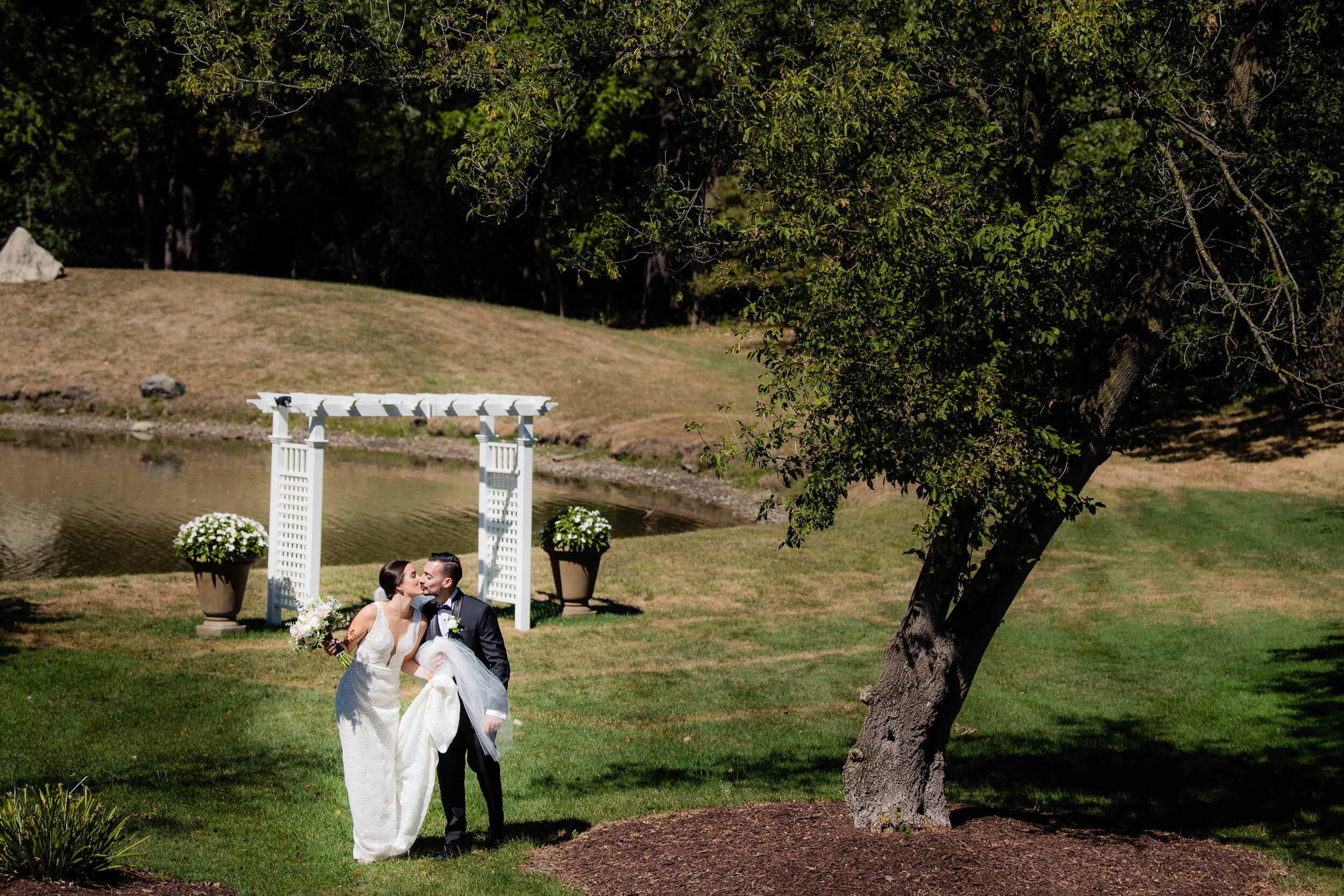 Bride and groom kiss at the Oakbrook Bath &amp; Tennis Club:  Chicago wedding photography by J. Brown Photography.