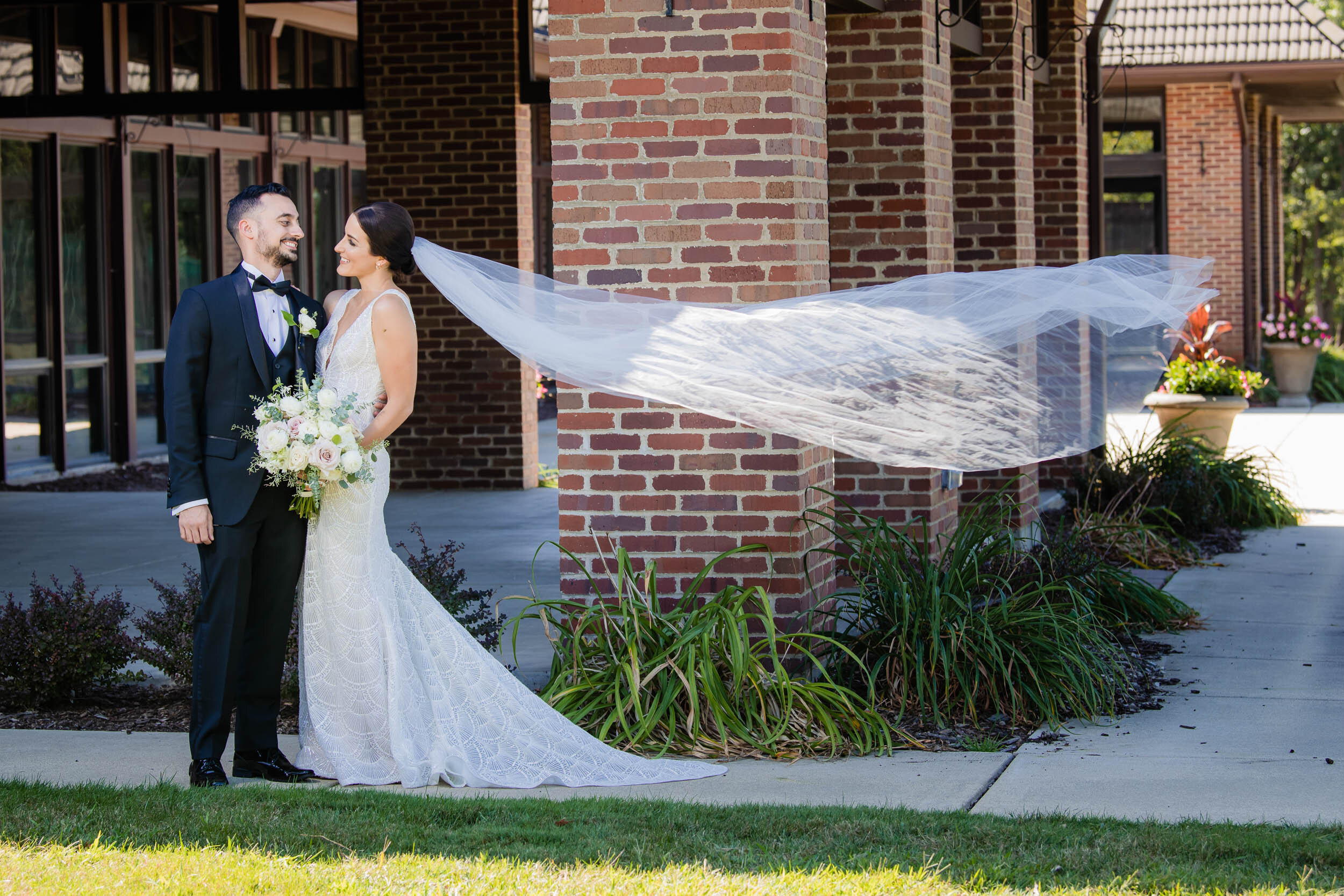 Brides veil blows in the wind:  Chicago wedding photography by J. Brown Photography.