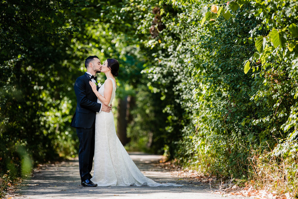 Bride and groom kiss near Graue Mill:  Chicago wedding photography by J. Brown Photography.