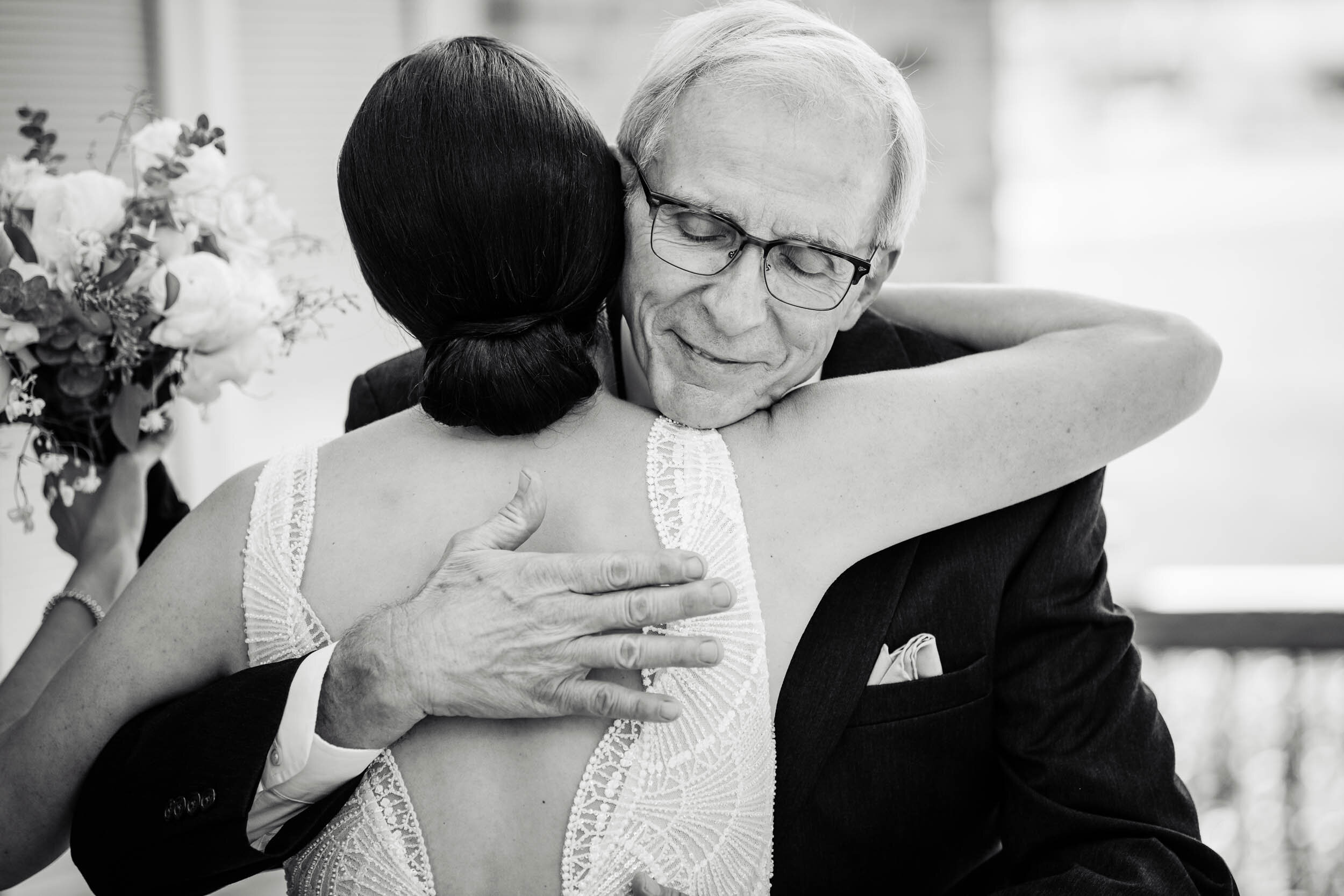 Father and daughter hug before the ceremony: Chicago wedding photography by J. Brown Photography.