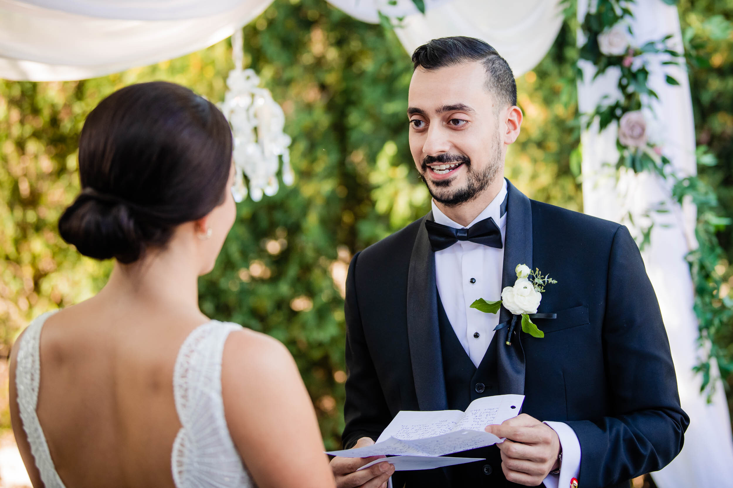 Groom says his vows during a backyard wedding ceremony: Chicago wedding photography by J. Brown Photography.