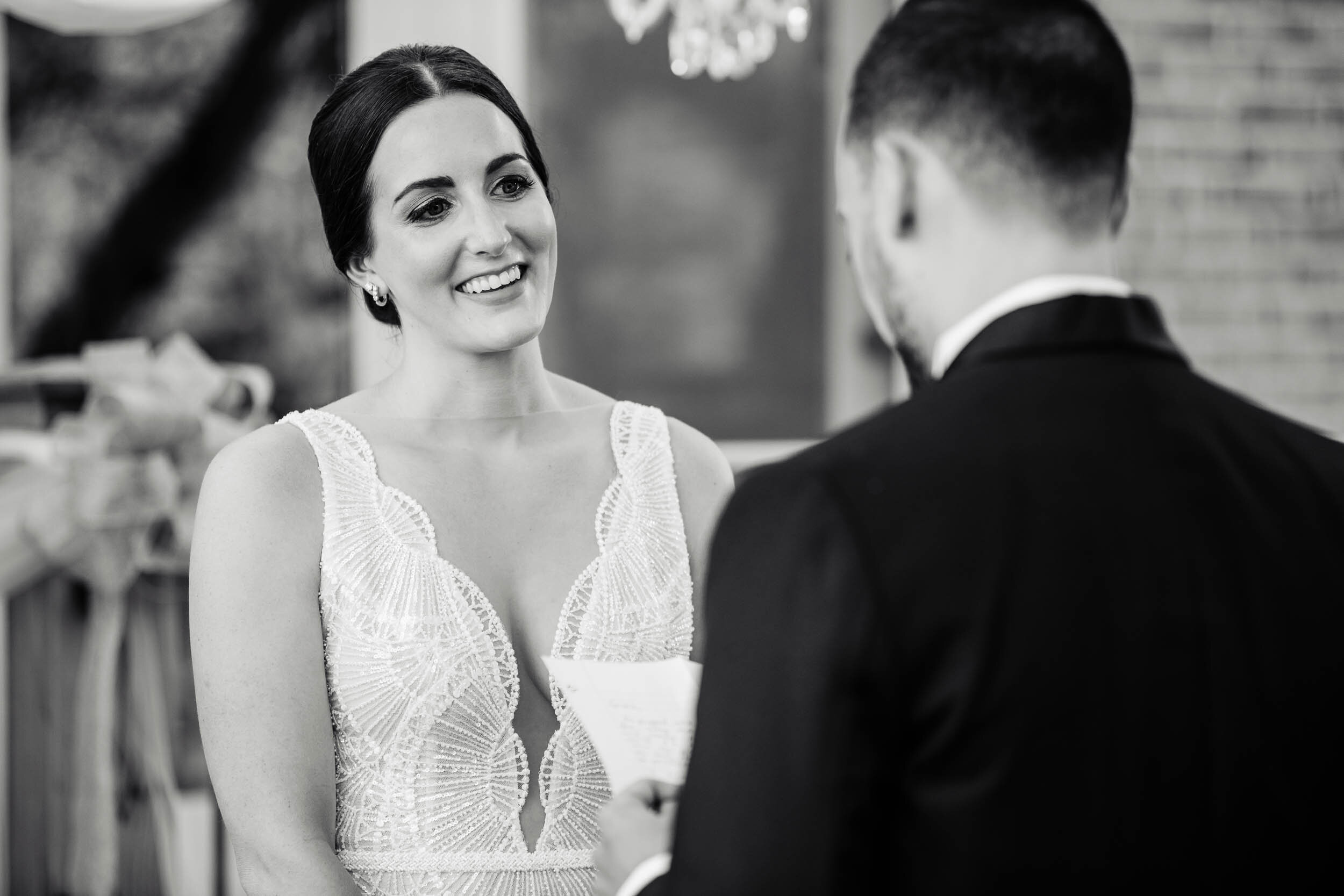 Bride reacts to the groom saying his vows:  Chicago wedding photography by J. Brown Photography.