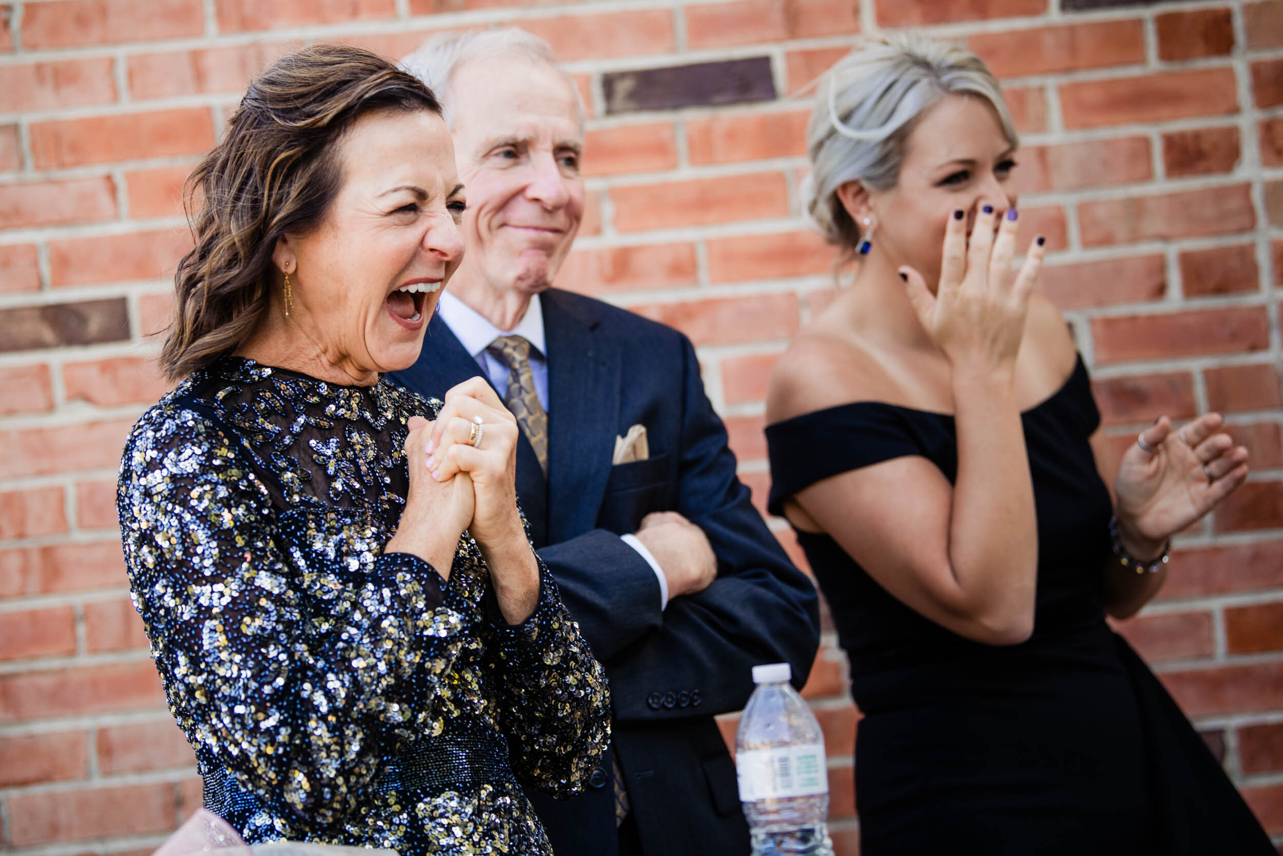 Father cheers for the newly wed couple:  Chicago wedding photography by J. Brown Photography.