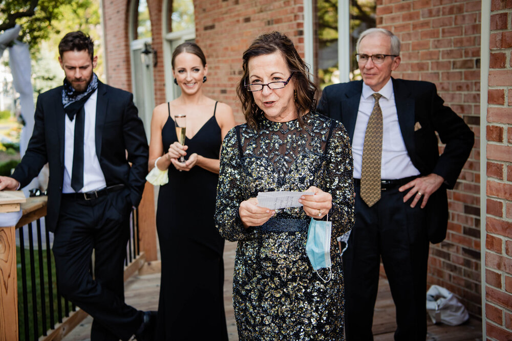 Mother of the bride speech during a home wedding reception:  Chicago wedding photography by J. Brown Photography.