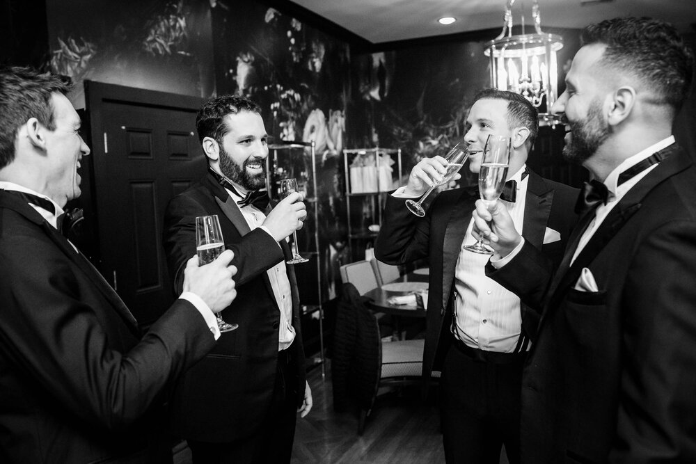 Groom and groomsmen toasting while getting ready:  Chicago wedding photographs by J. Brown Photography.